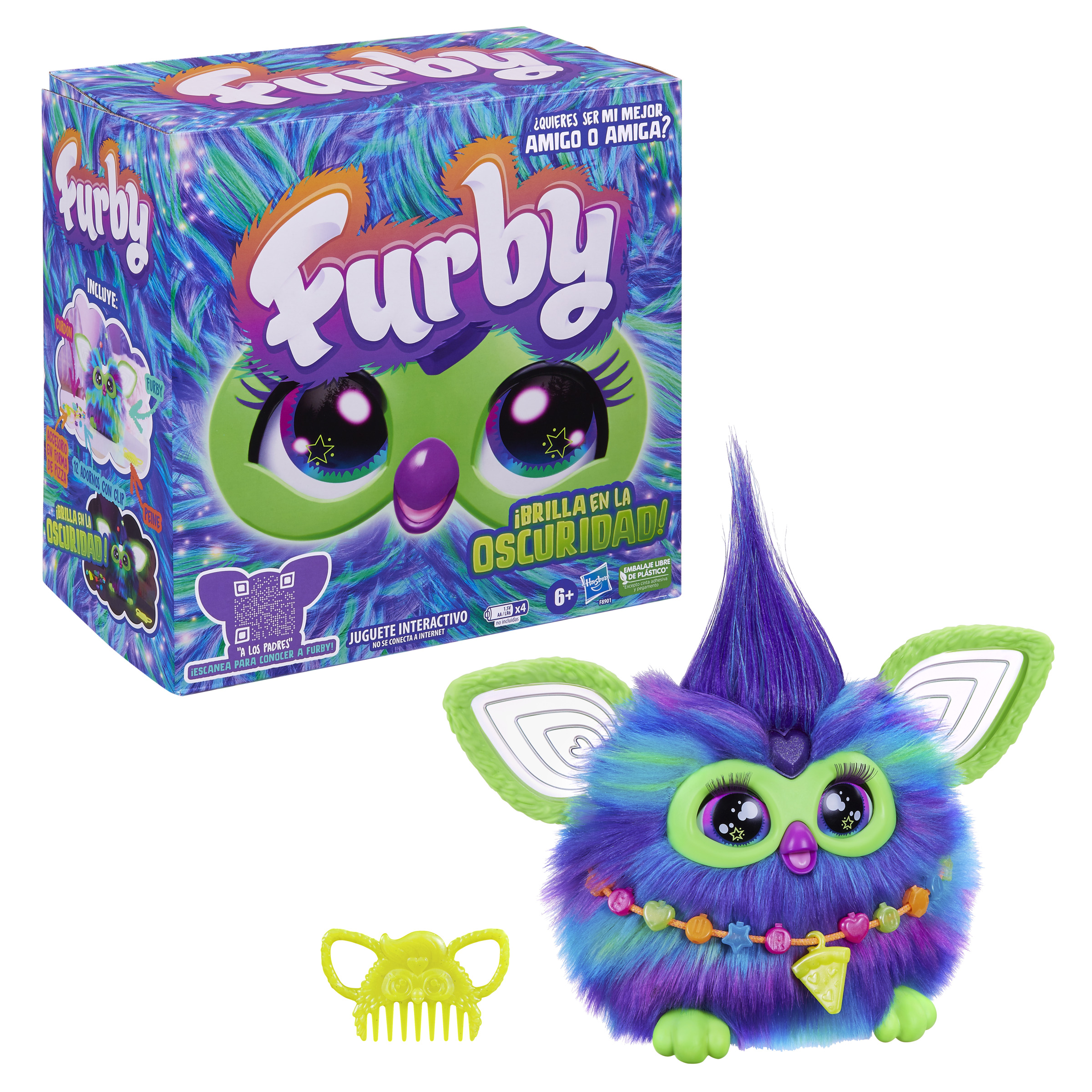 Juguete Furby con pelaje morado, azul y verde. Tiene una caja con texto y un peine amarillo.