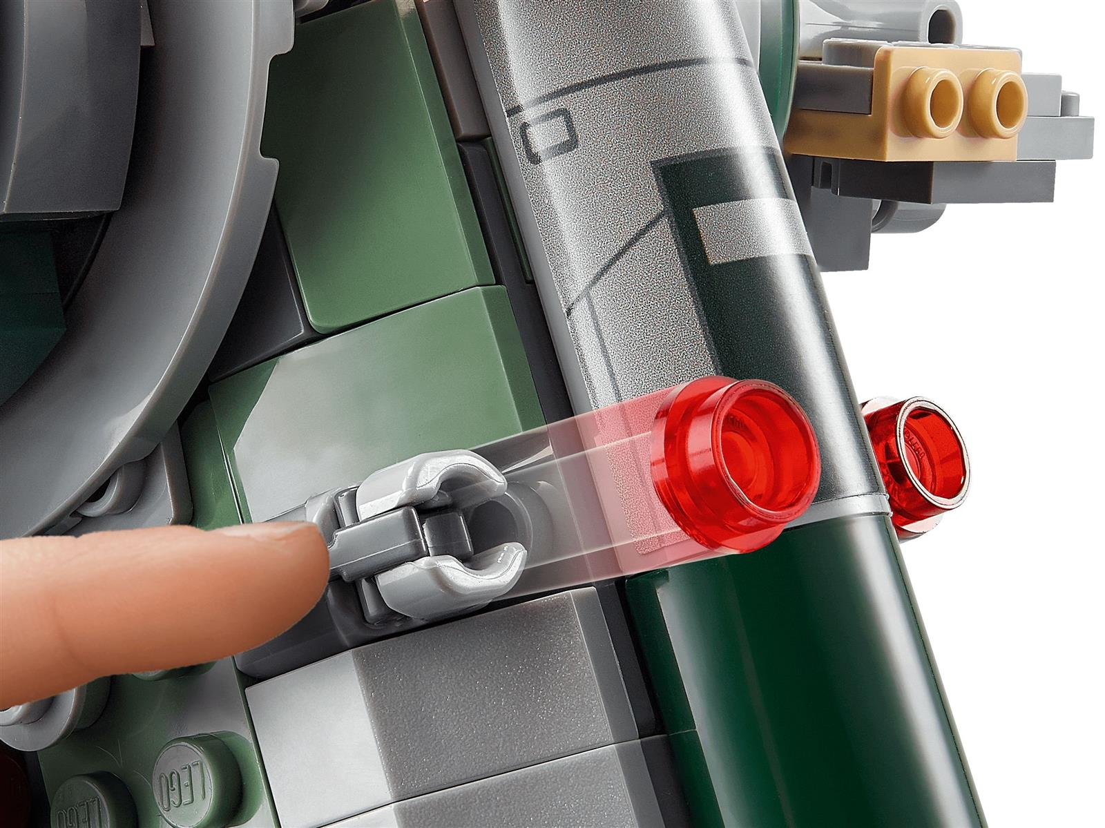 Primo piano di un modello Lego. Un dito tocca un morsetto grigio con luci rosse e blocchi verdi e grigi sullo sfondo.