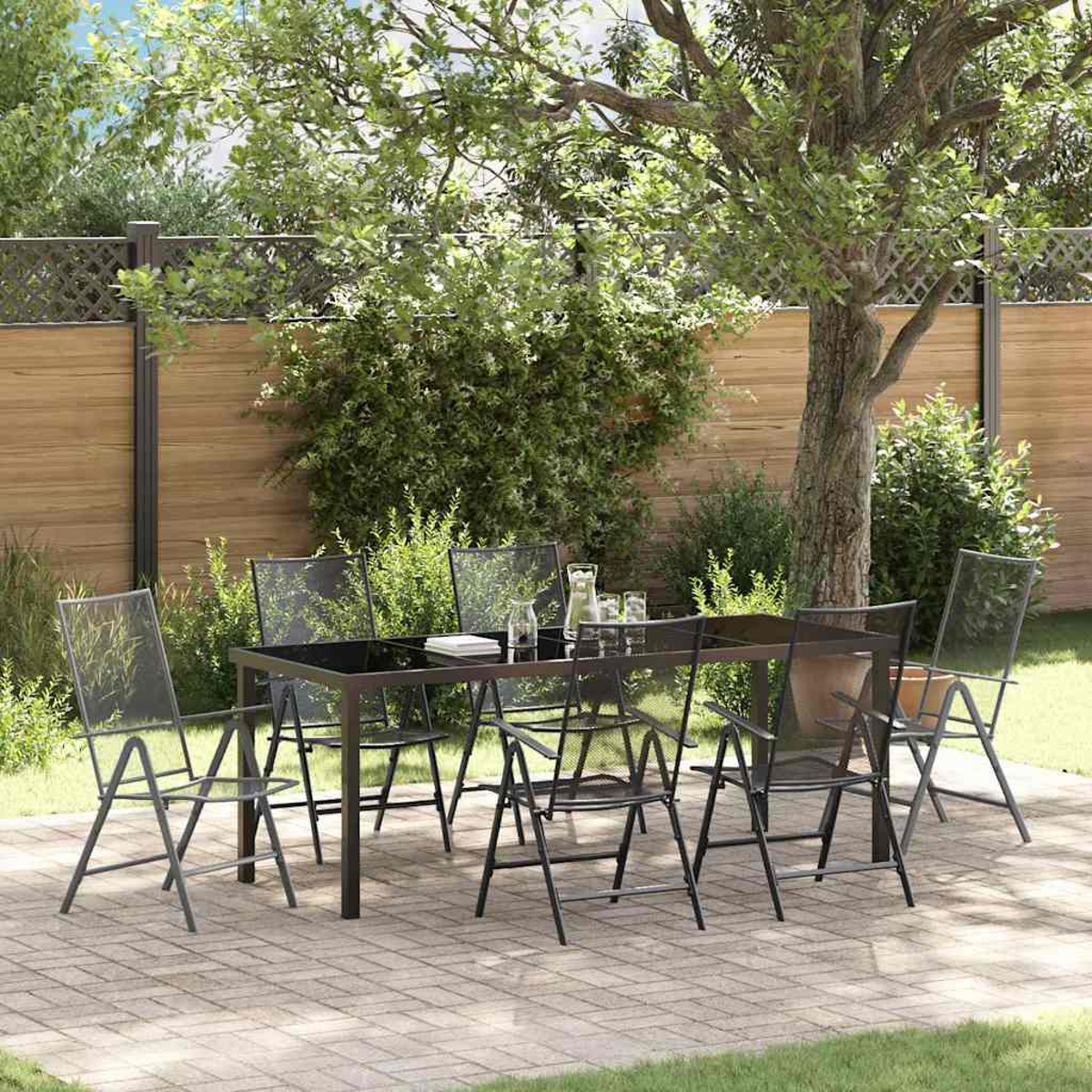 Eine Szene auf der Terrasse mit einem schwarzen Tisch und Stühlen. Ein Baum steht hinter dem Tisch. Ein Holzzaun ist im Hintergrund.