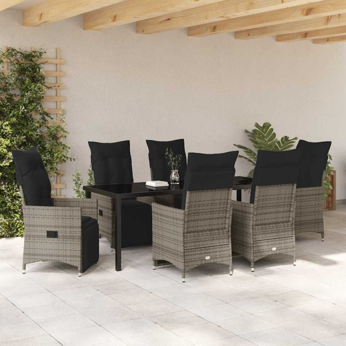 Essgruppe für draußen mit sechs Stühlen, schwarzen Kissen und einem Tisch mit Glasplatte auf einer Terrasse. Pflanzen und eine Holzdecke sind sichtbar.
