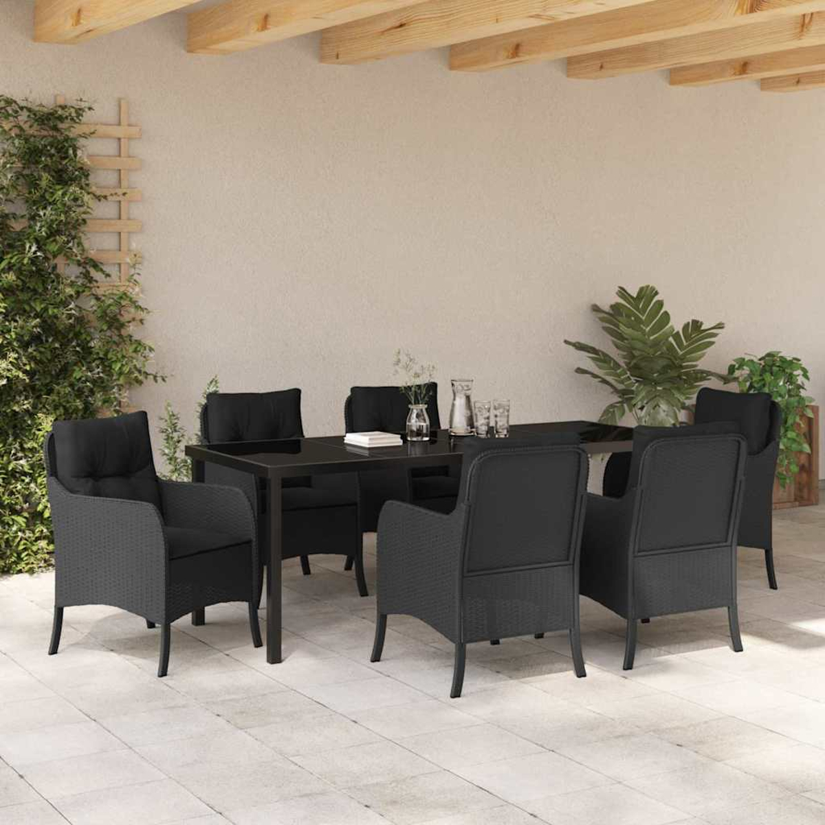 Essgruppe im Freien mit schwarzen Stühlen und einem Tisch. Pflanzen und Holzbalken sind im Hintergrund.