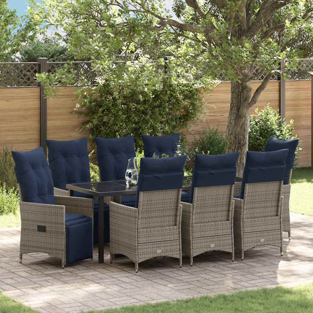Ein Terrassenset mit Tisch und Stühlen. Die Stühle haben blaue Kissen. Im Hintergrund ein Zaun und Bäume.