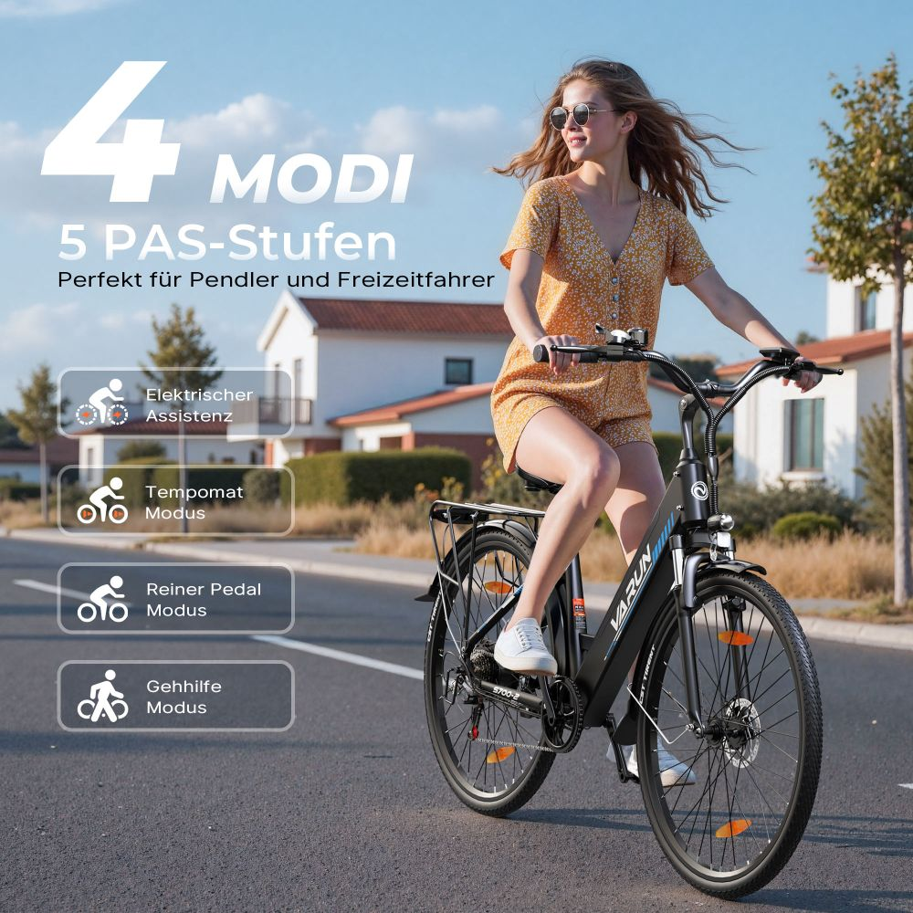 Una mujer monta en bicicleta eléctrica negra en una carretera. Lleva gafas de sol y un conjunto amarillo. La bicicleta tiene un portaequipajes.