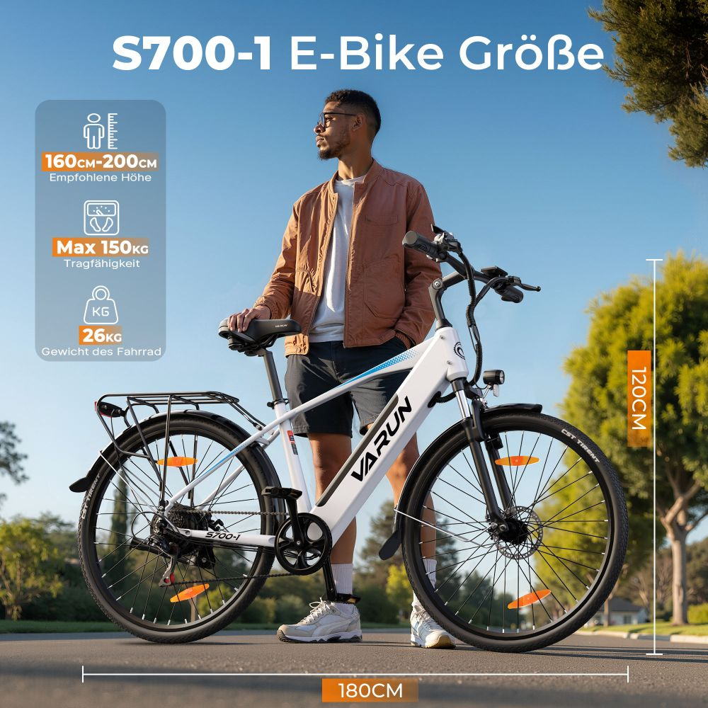 Hombre de pie junto a una e-bike Varun blanca y negra. Se muestran las especificaciones de la bicicleta. Dimensiones 180x120cm. Peso máximo 150kg, peso de la bici 26kg.