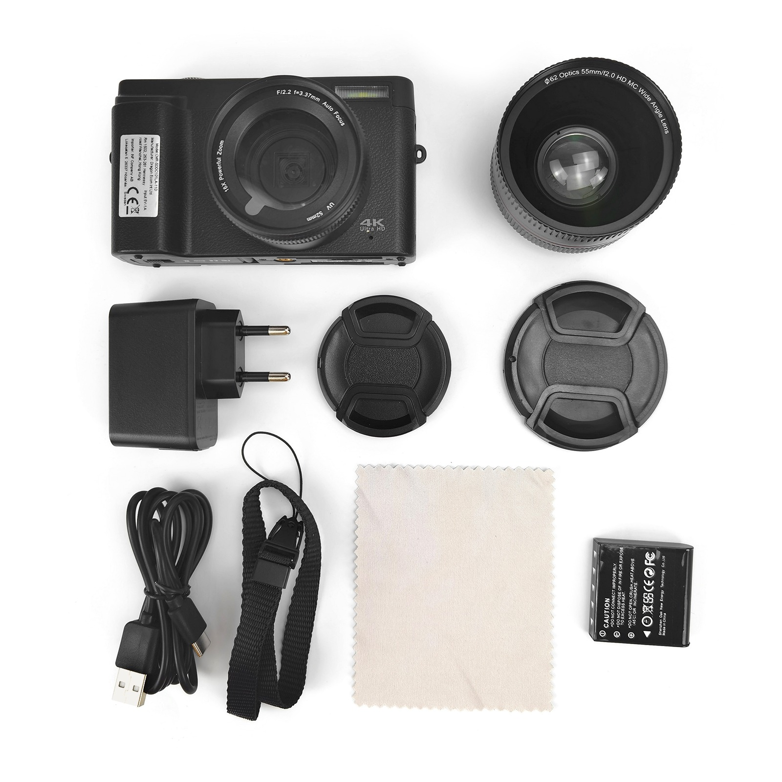 Czarny zestaw aparatu na białym tle. Zawiera aparat, obiektyw, ładowarkę, kabel, osłony, baterię, ściereczkę i pasek.