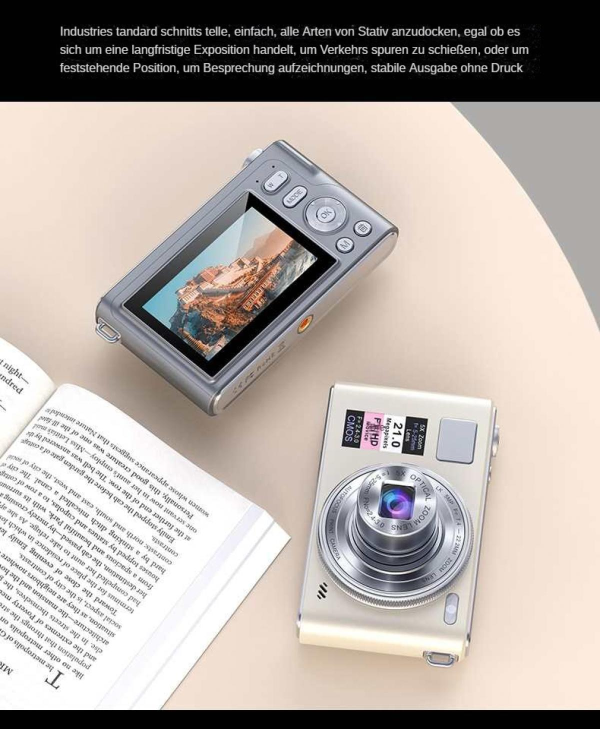 Zwei Digitalkameras, eine silberne und eine weiße, auf einer hellen Oberfläche. Ein Buch befindet sich unten links.
