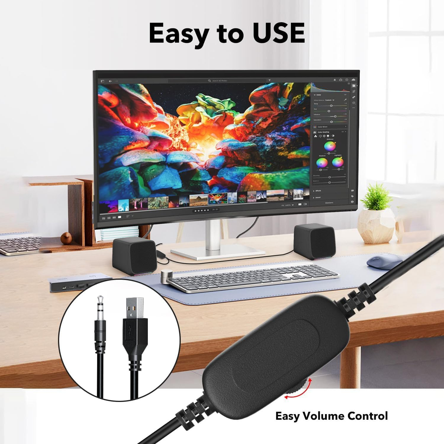 Ein Computer-Setup mit einem Monitor, der Bearbeitungssoftware anzeigt, Lautsprechern und Lautstärkeregelung. Kabel und Anschlüsse sind ebenfalls sichtbar.