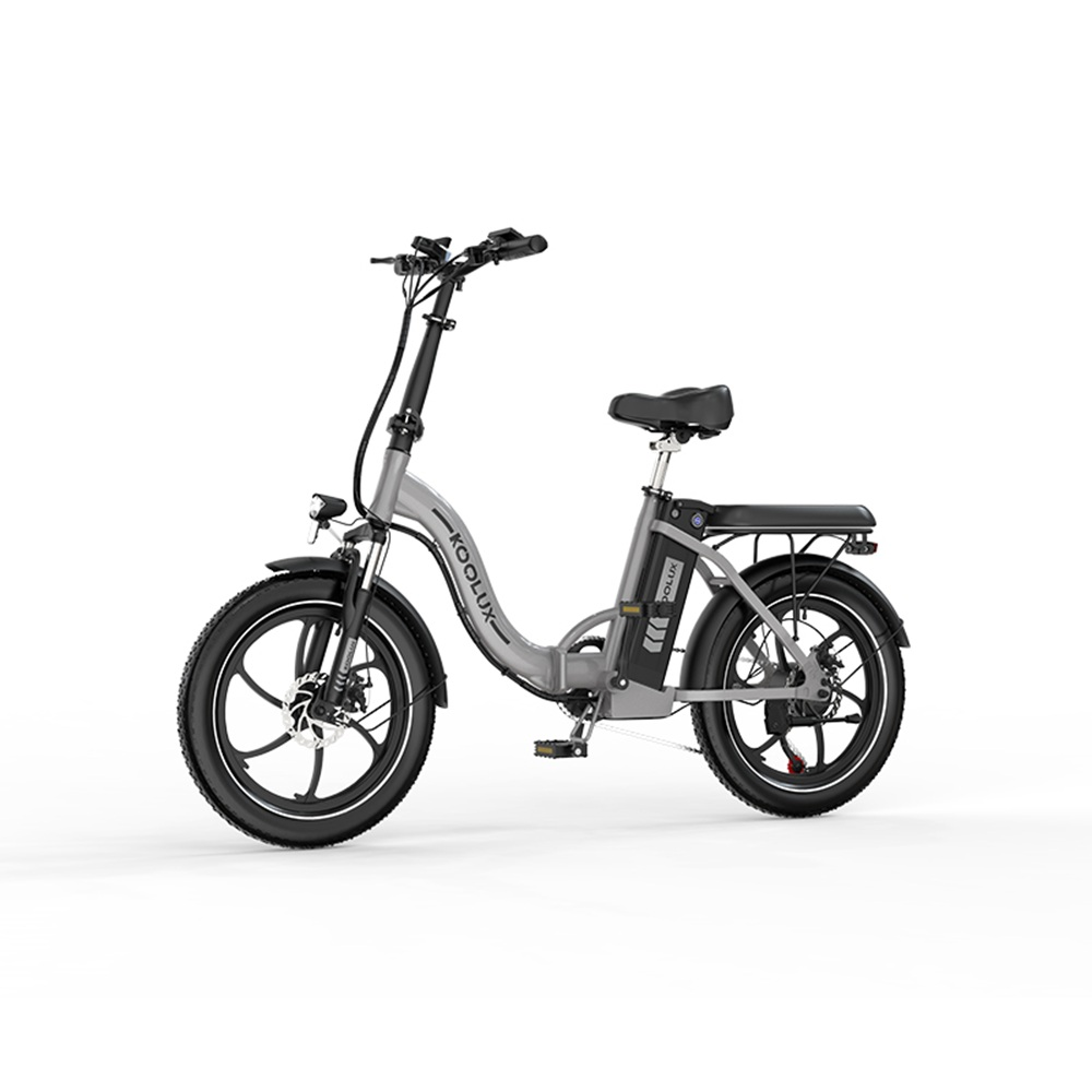 Bicicleta eléctrica plegable gris, marca 'KOOLUX' visible. Neumáticos y asiento negros, con batería y portaequipajes trasero.