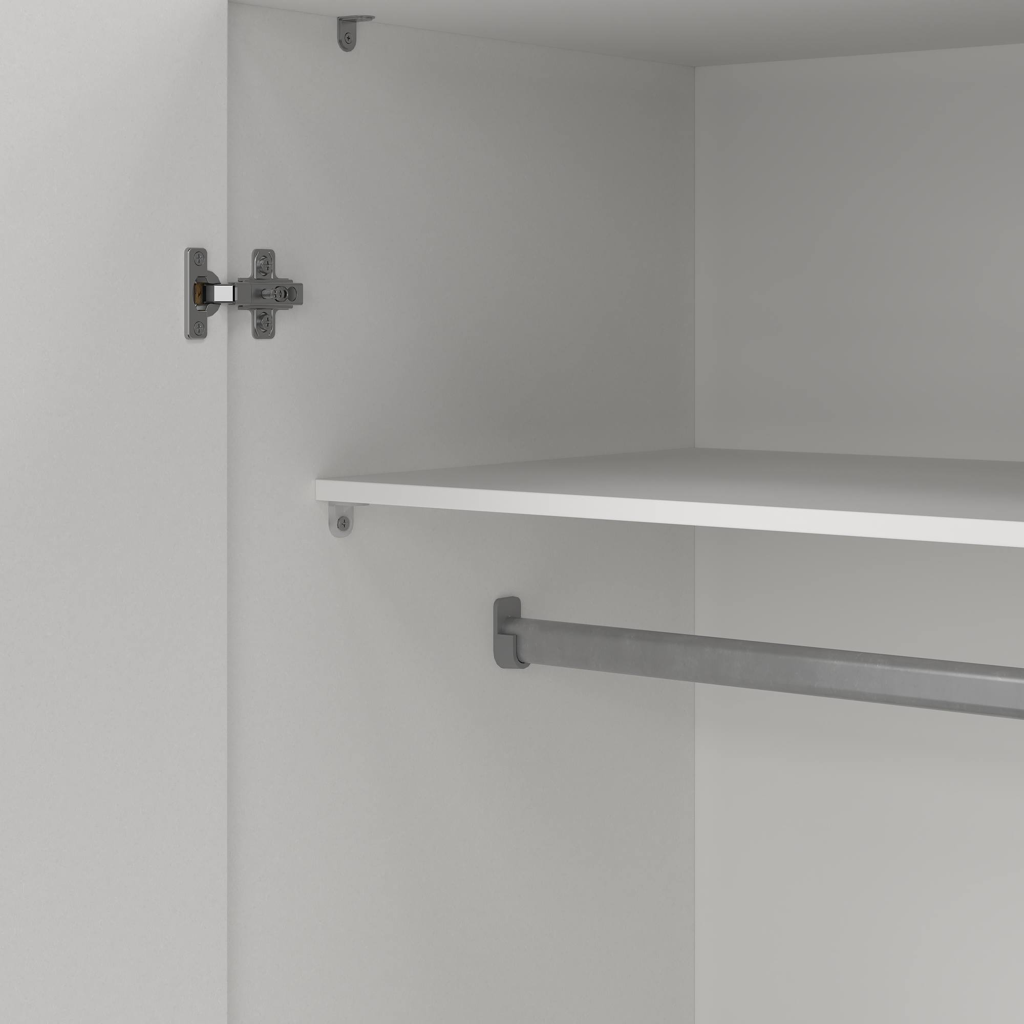 Interior de un armario blanco con estante y barra metálica para ropa. Bisagras visibles.
