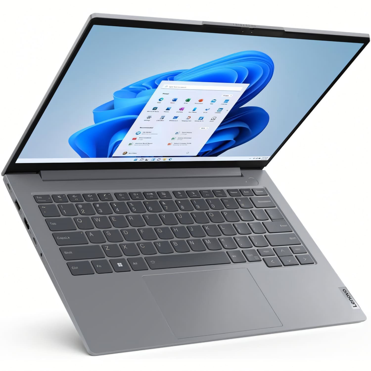 Un portátil Lenovo gris está abierto, mostrando una interfaz de Windows 11. La pantalla muestra un fondo azul abstracto e iconos de aplicaciones.