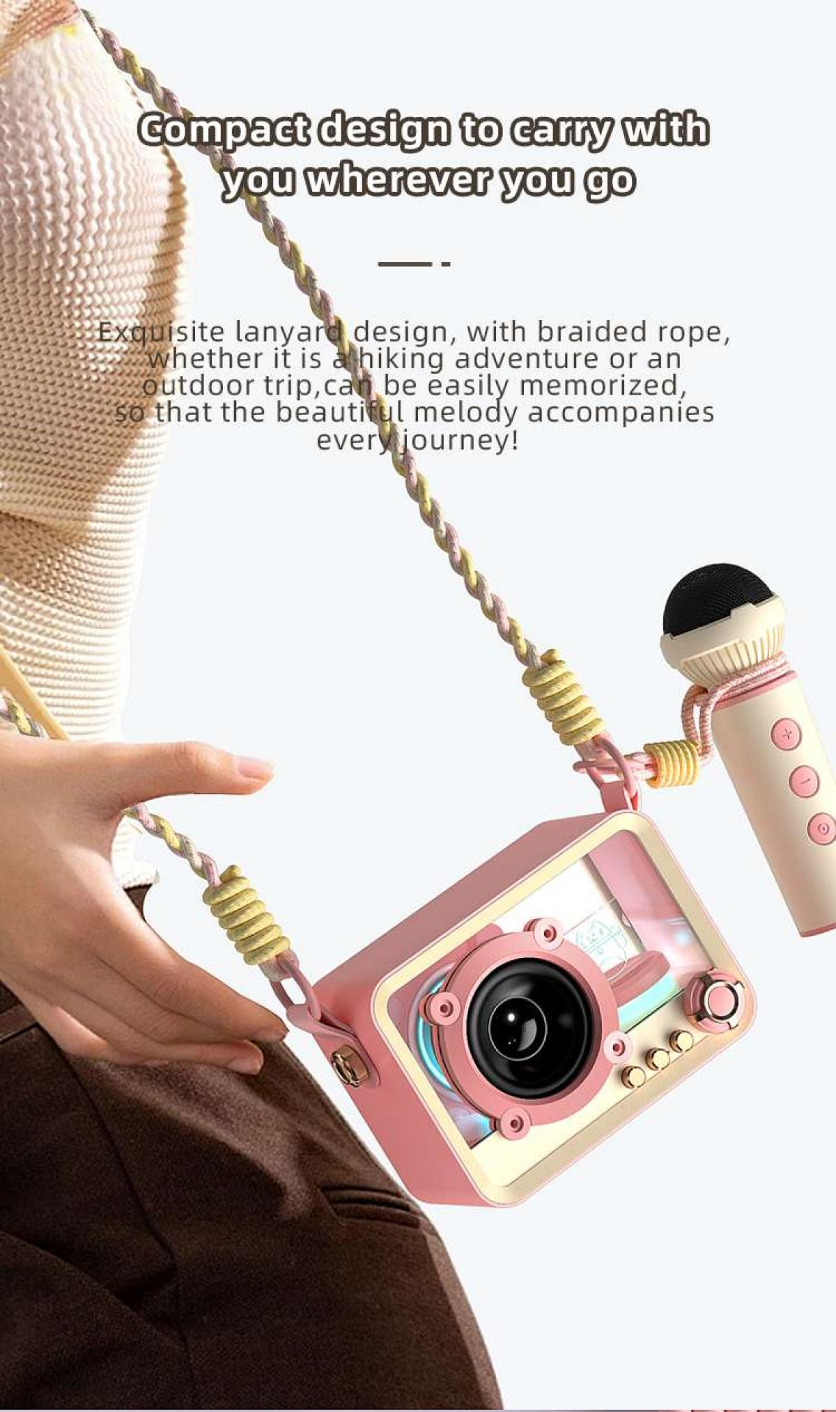 Eine rosa Kamera mit Mikrofon wird von einer Hand gehalten. Ein geflochtenes Seil verbindet Kamera und Mikrofon.