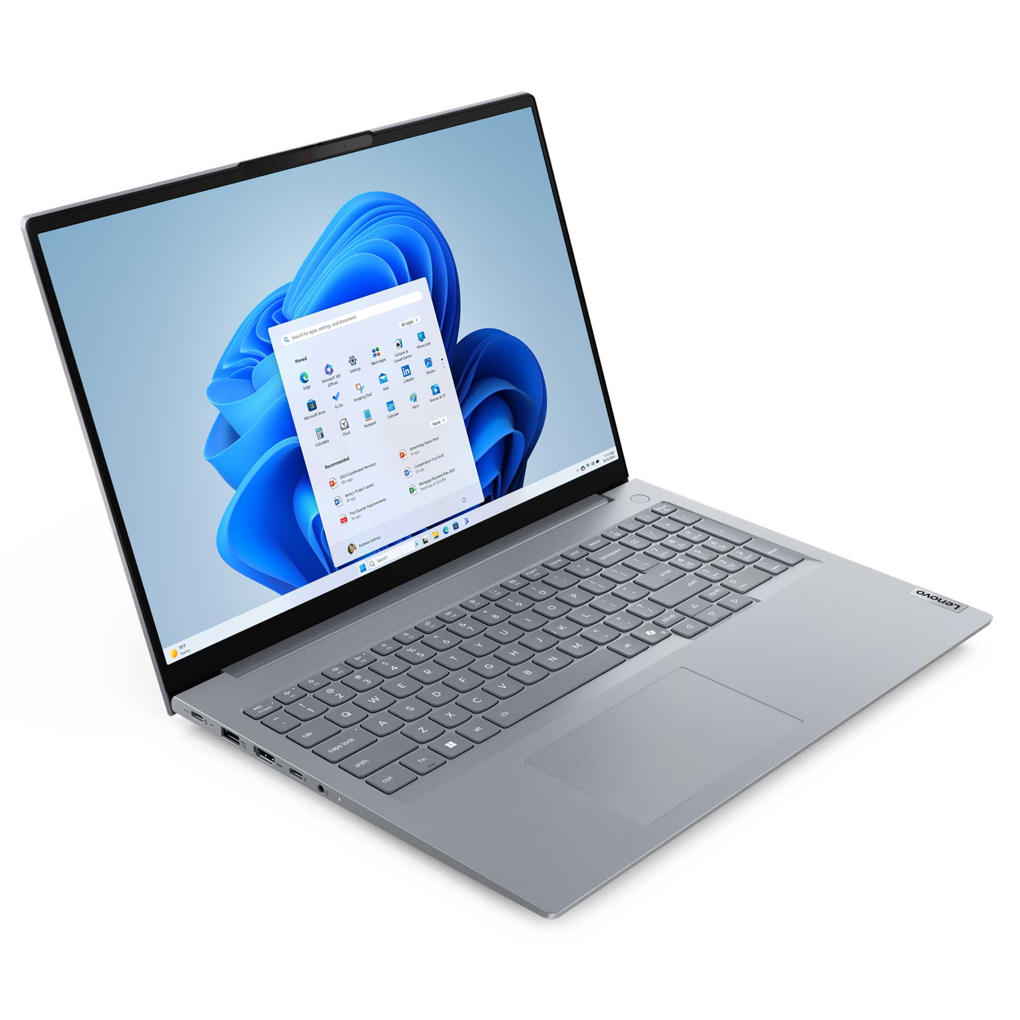 Bir Lenovo dizüstü bilgisayar açık, Windows 11 arayüzünü gösteriyor. Ekran, uygulama simgelerini ve mavi bir arka planı gösteriyor.