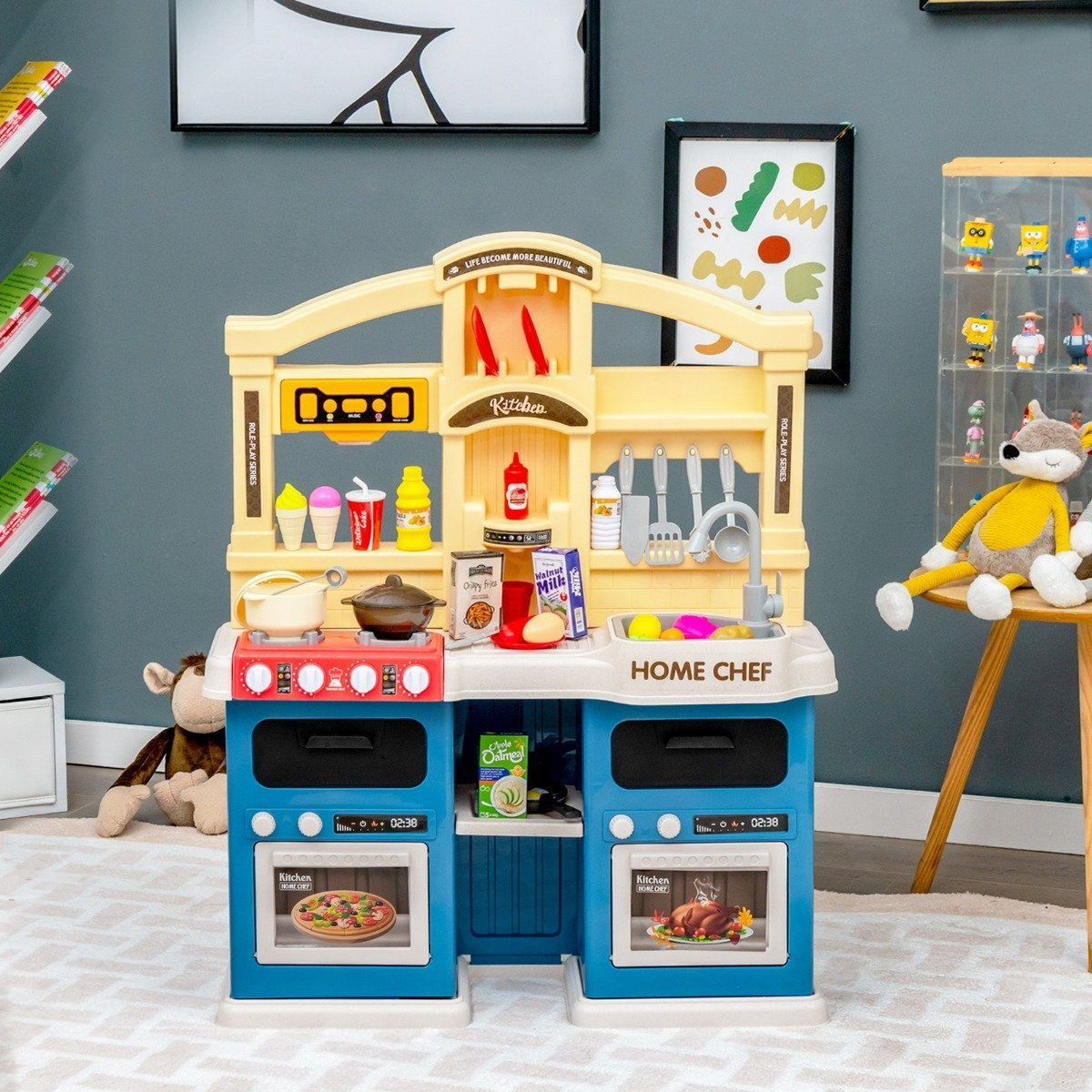 Un juego de cocina de juguete con varios accesorios como ollas, sartenes y alimentos. Tiene una combinación de colores azul y amarillo.