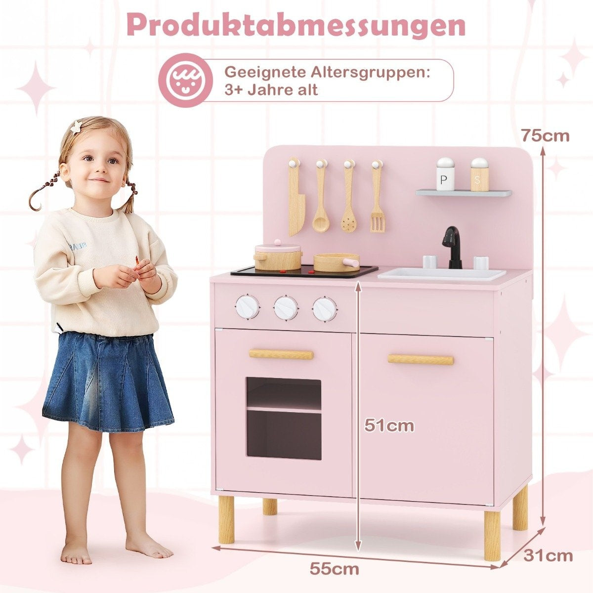 Una niña está de pie junto a una cocina de juguete rosa. La cocina tiene una estufa, un fregadero y accesorios. Se muestran las dimensiones.