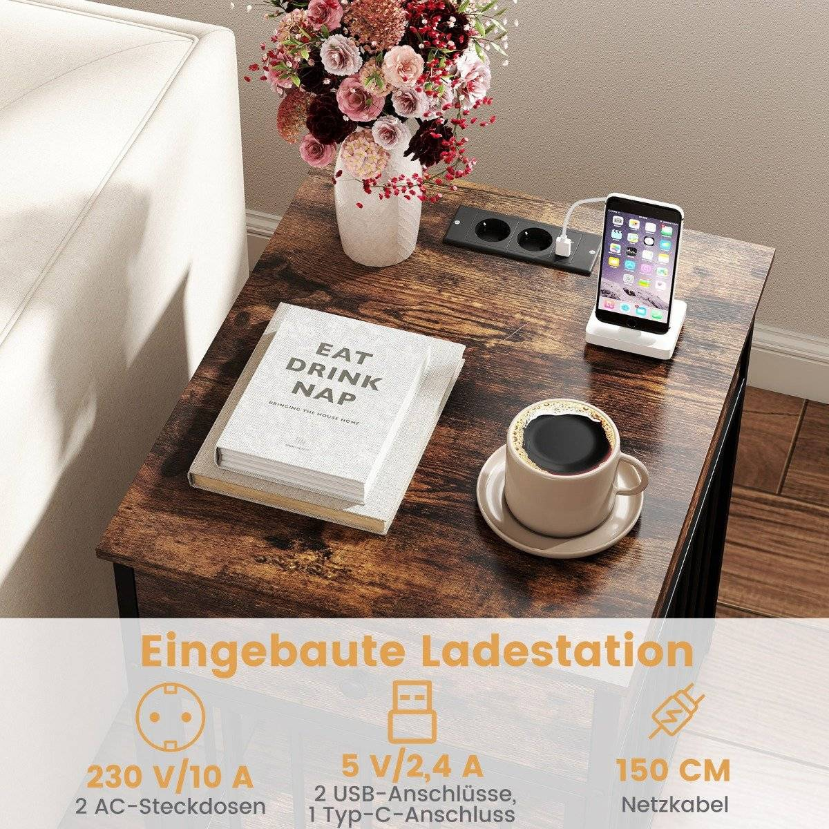 Una mesa auxiliar con una taza de café, teléfono, libro y flores. Tiene una estación de carga integrada.