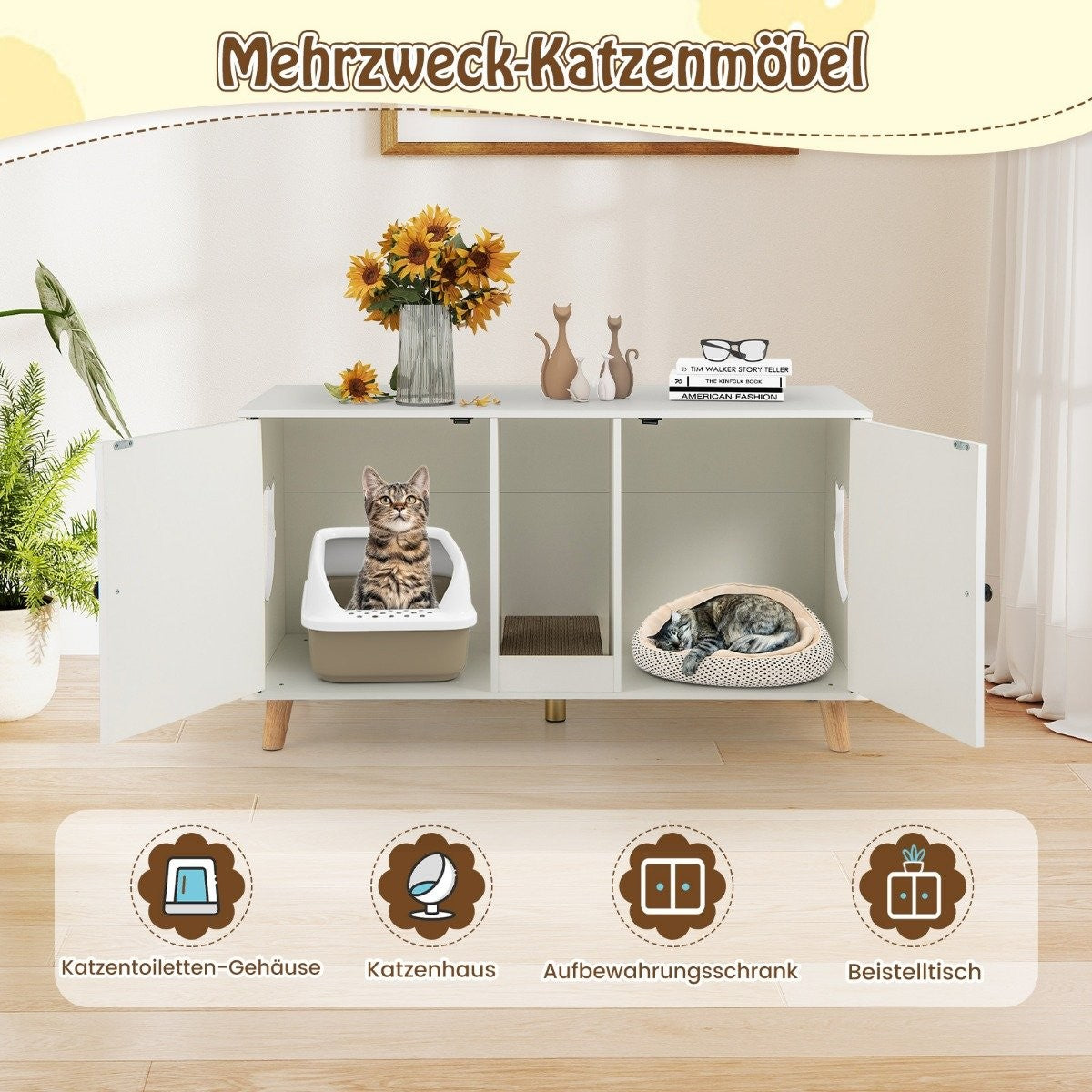 Un mueble blanco para gatos. Un gato está en una caja de arena, otro duerme en una cama. Girasoles y decoración encima.