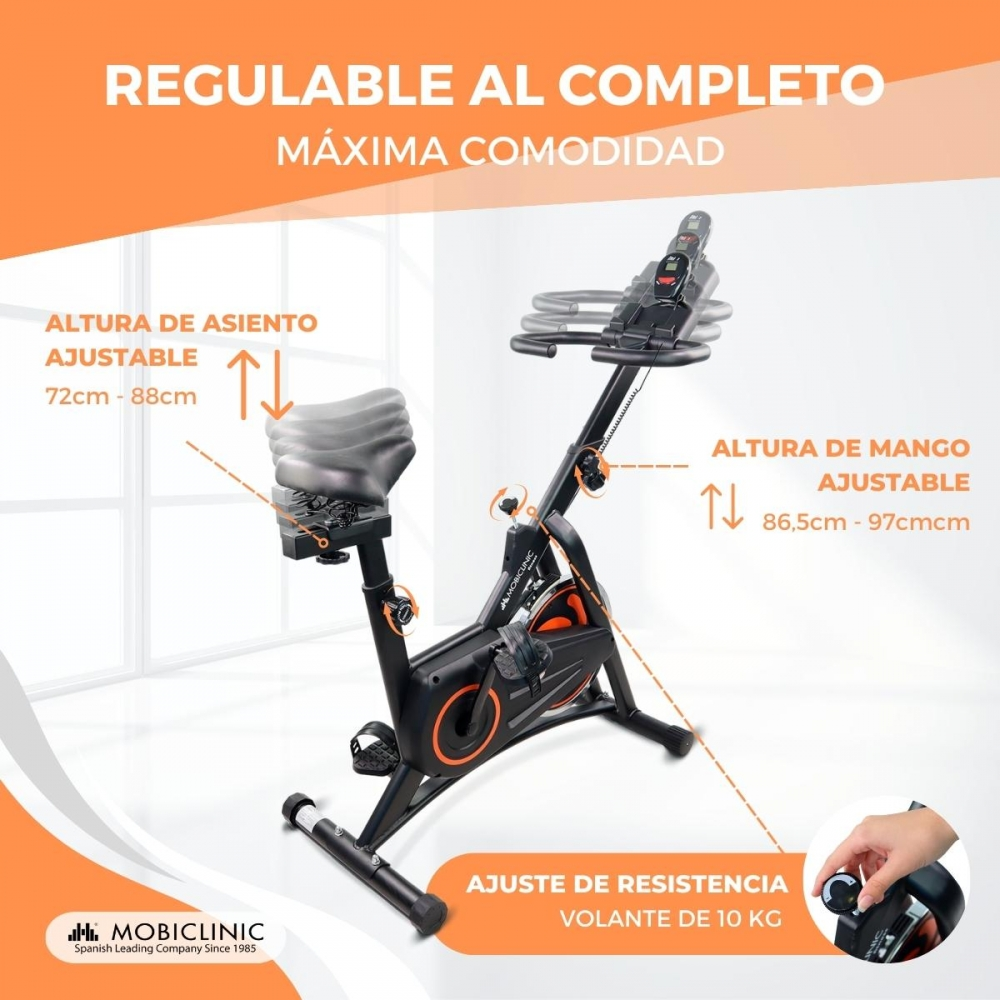 Se muestra una bicicleta de ejercicio negra y naranja. Tiene asiento y manillar ajustables. La bicicleta tiene una perilla de ajuste de resistencia.