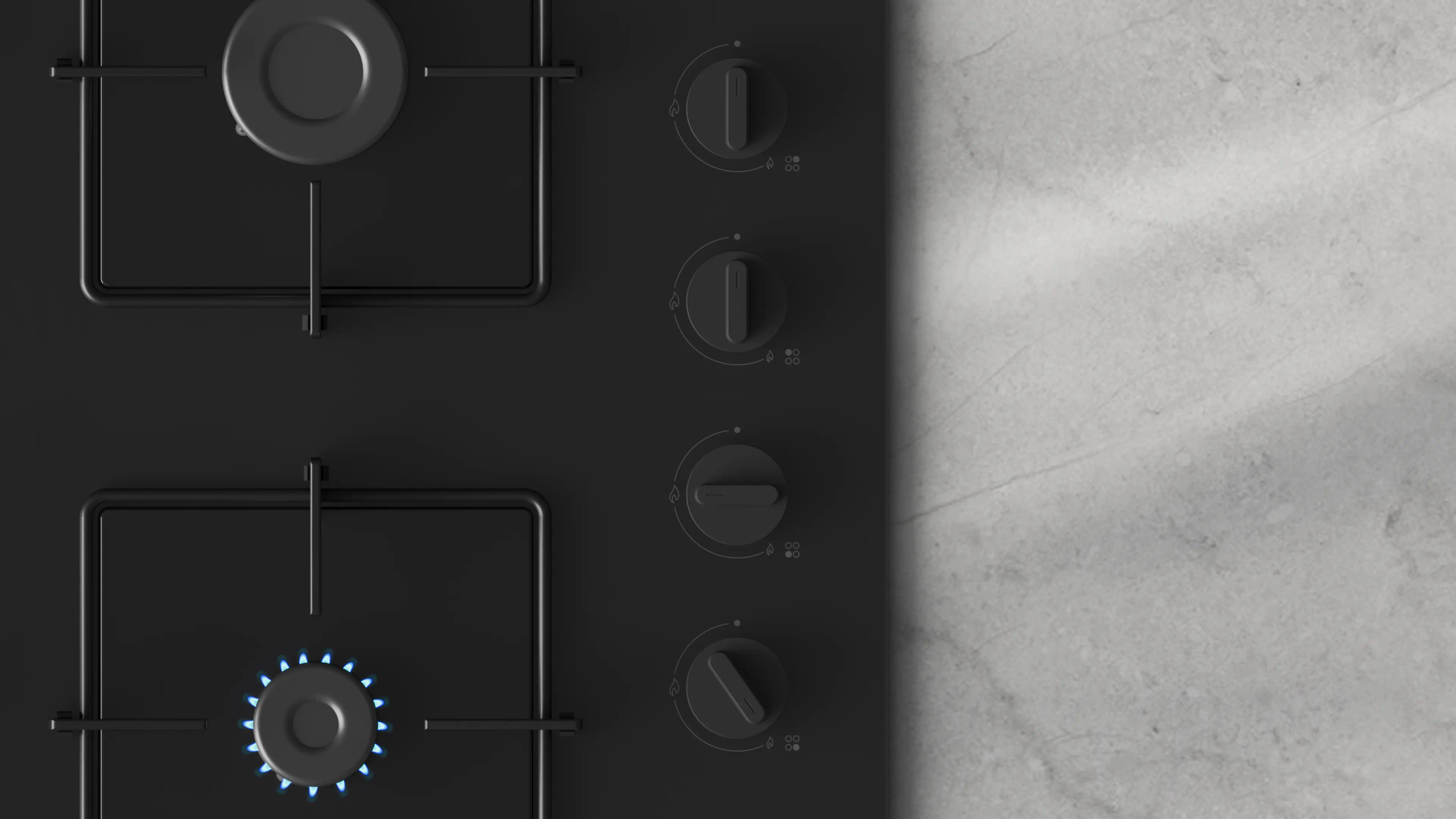 Piano cottura nero con bruciatori, manopole e fiamma blu accesa. Superficie in marmo grigio a destra.