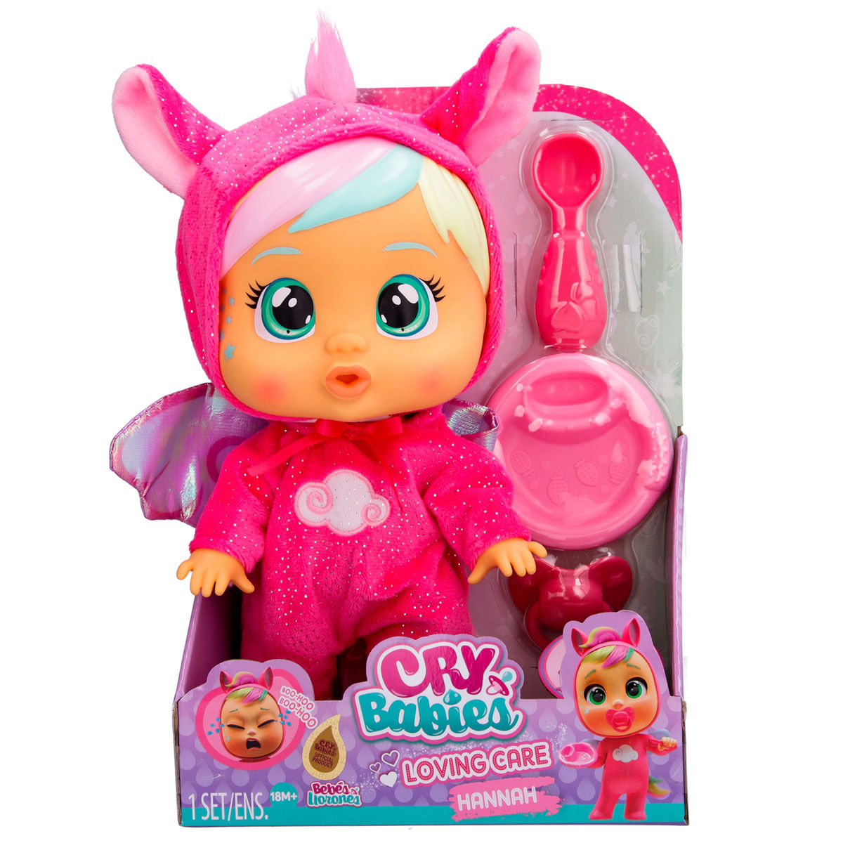 Una muñeca Cry Babies con un disfraz de unicornio rosa está en una caja. Los accesorios incluyen una cuchara, un biberón y un chupete. La caja dice 'Loving Care'.