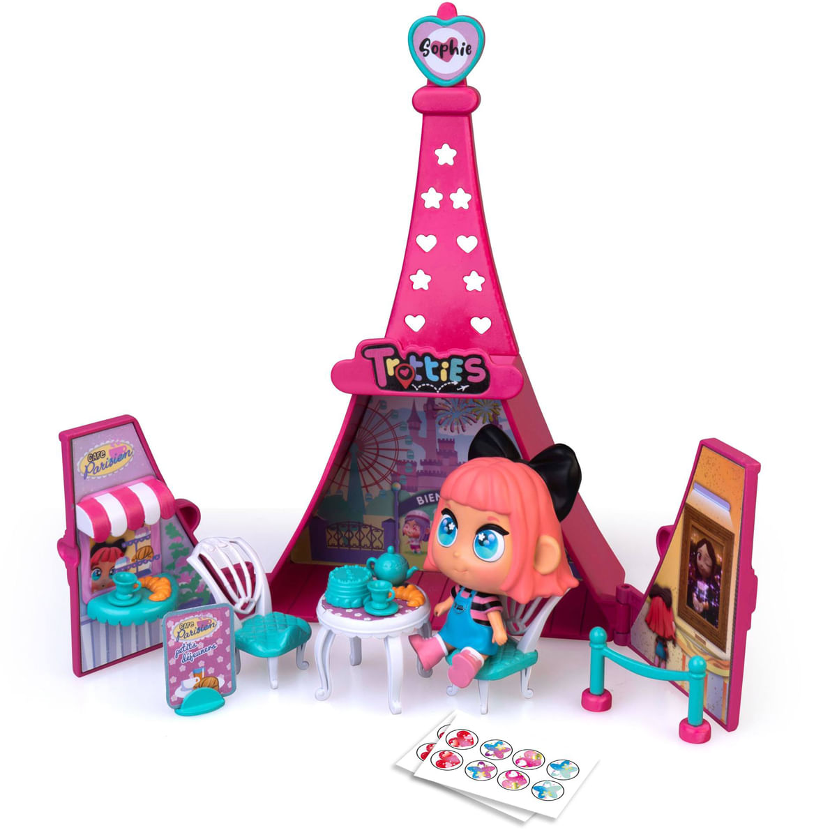 Un juego de juguetes de la Torre Eiffel rosa. Una muñeca está sentada en una mesa con té. Accesorios de café y escena artística rodean la torre. Pegatinas en el suelo.
