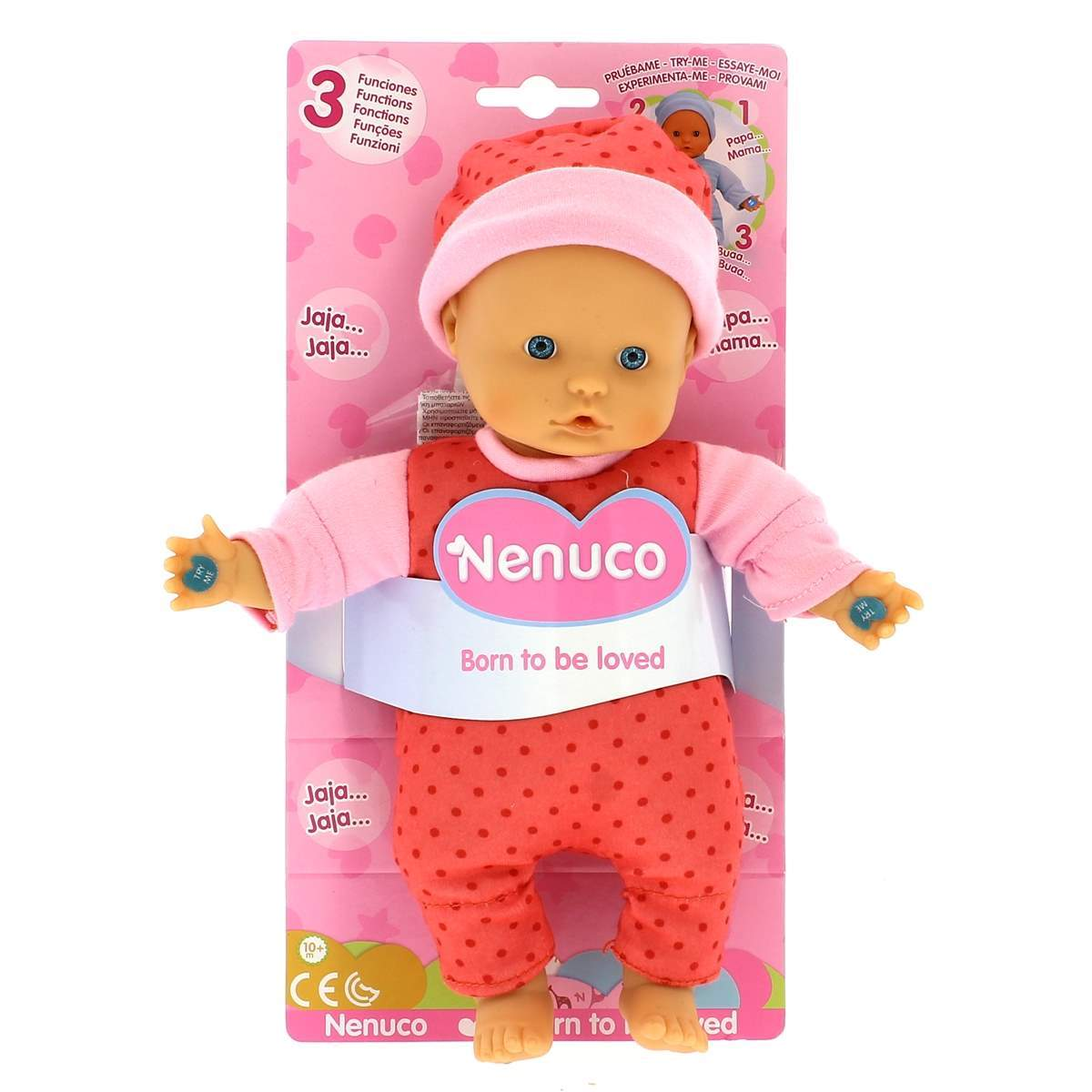 Una muñeca Nenuco con gorro y pijama de lunares rosas. La muñeca está en una tarjeta rosa con texto en varios idiomas.