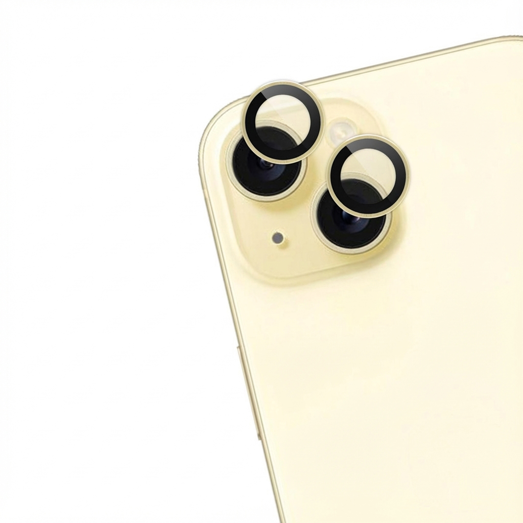 Close-up of a phone back. Three black camera lenses with gold rims are visible.