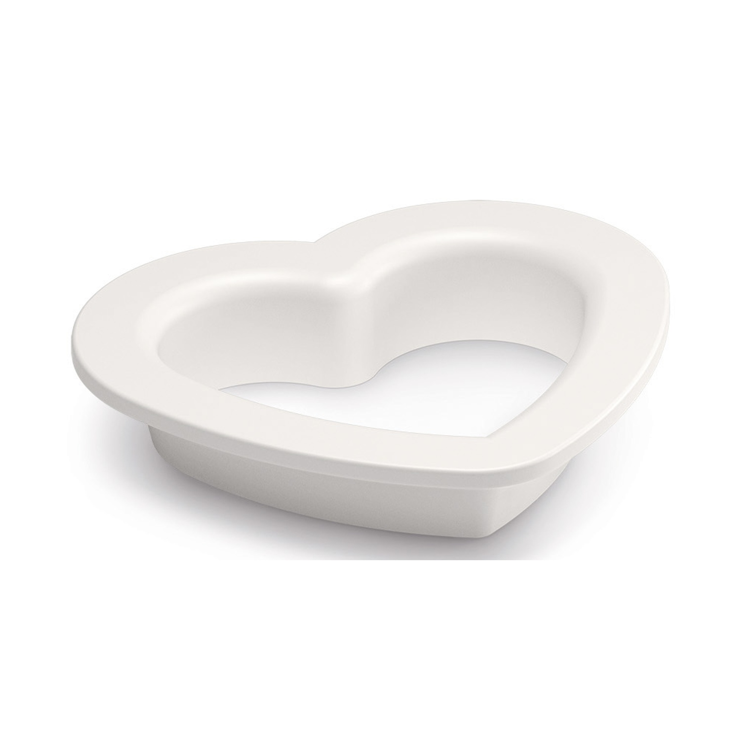 A white heart-shaped object, possibly a mold or container, sits against a white background.