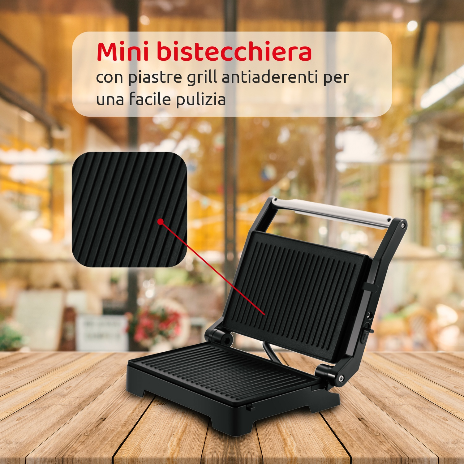 Mini parrilla negra sobre mesa de madera. Abierta. Primer plano muestra la superficie. Texto en italiano: 'Mini grill'.