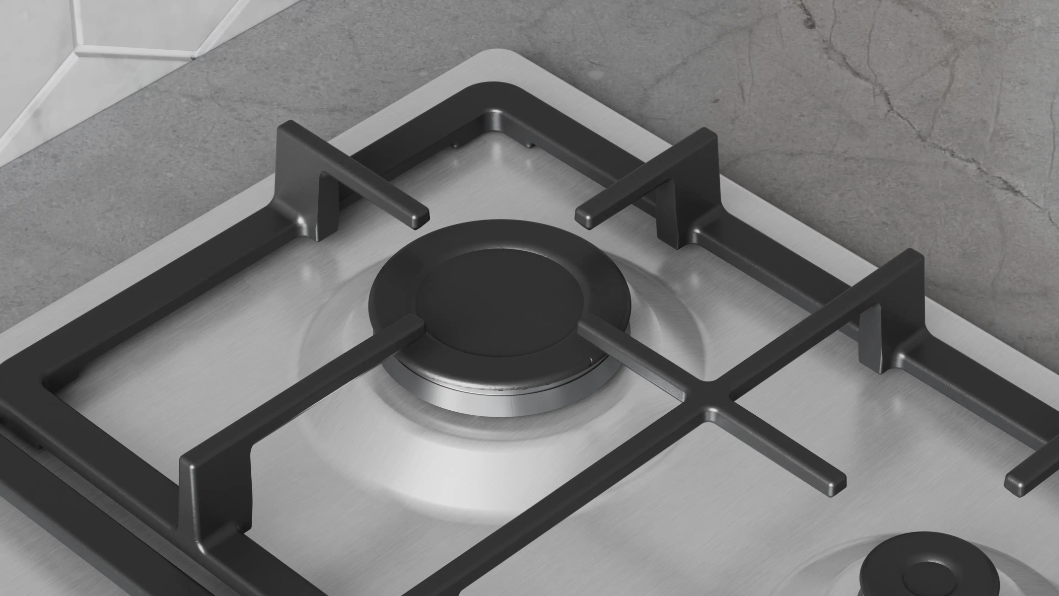 Primer plano de una cocina de gas. Rejillas y quemador negros sobre una superficie plateada. Fondo de mármol gris.