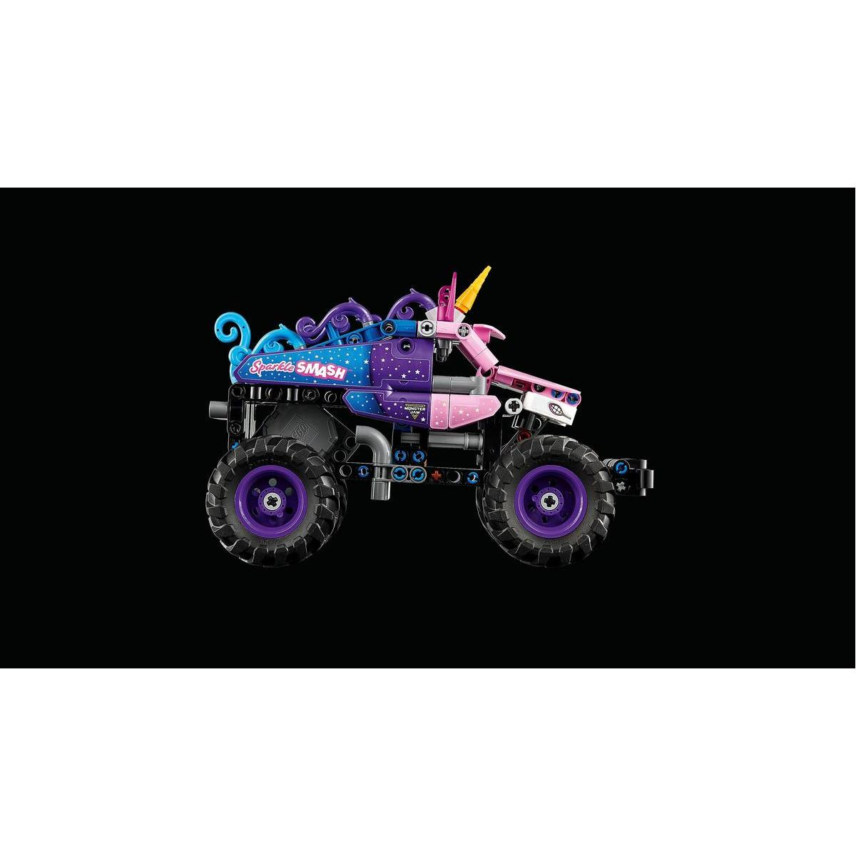 Zabawkowa ciężarówka potworów, w tematyce jednorożca, z fioletowymi kołami i różowo-niebieskim nadwoziem, na czarnym tle. Ciężarówka ma napis 'Sparkle Smash'.