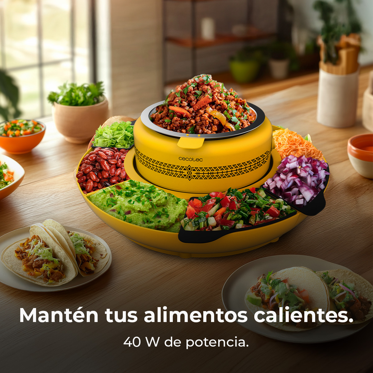 Uno scaldavivande giallo con vari scomparti per alimenti. Vengono mostrati tacos, fagioli, guacamole e condimenti. Il testo recita: Tieni il cibo al caldo.