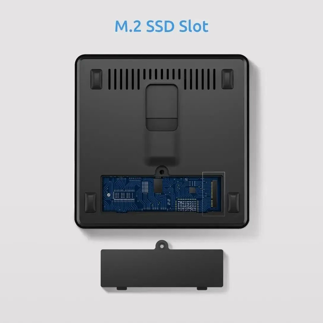 Componente de ordenador negro con ranura M.2 SSD. Se ve una placa de circuito azul. Una cubierta separada está debajo del componente.