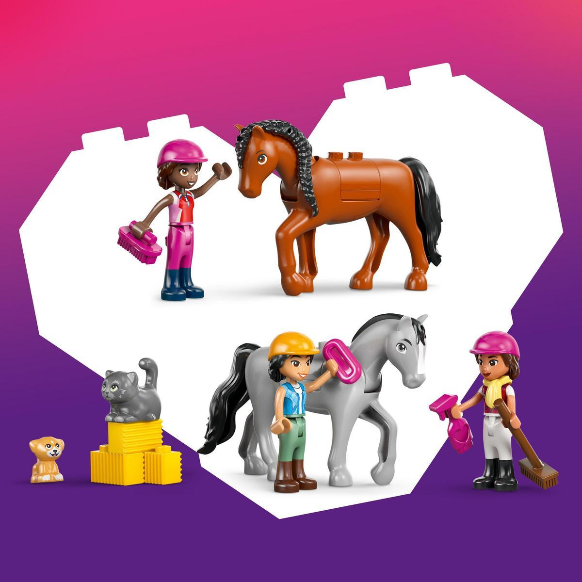 Escena con caballos de juguete, jinetes y mascotas. Un caballo marrón, un caballo gris y jinetes con accesorios. También hay un gato y un perro.