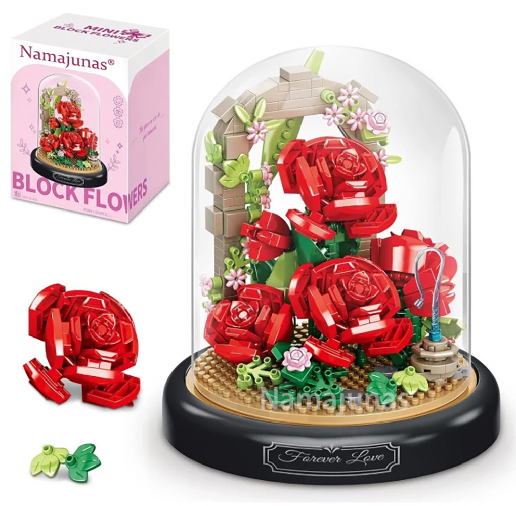 Ein Blockblumenset mit roten Rosen unter einer Glaskuppel. Es beinhaltet eine Box, montierte und unmontierte Rosen und grüne Blätter.