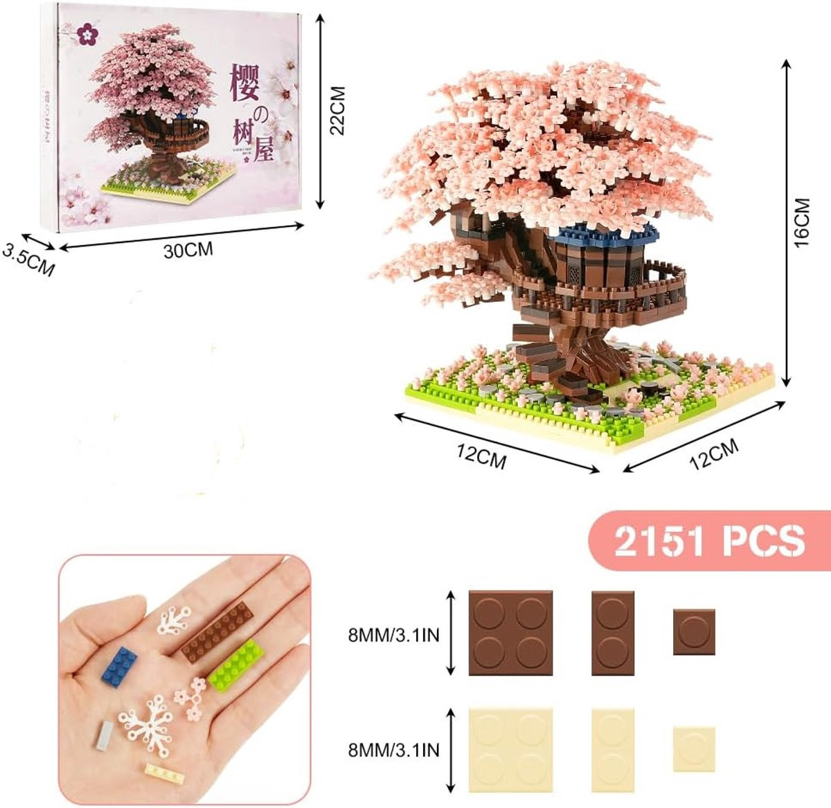 Eine Schachtel zeigt ein Baumhausmodell mit rosa Blüten. Das Modell steht auf einer grünen Basis. Kleine Blöcke und Teile sind abgebildet.