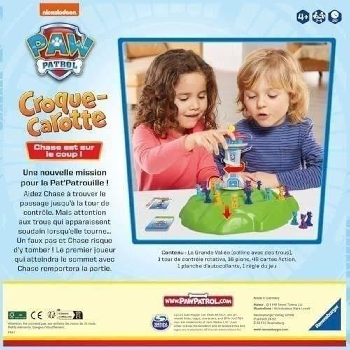 Due bambini giocano a un gioco da tavolo di Paw Patrol, con una torre e personaggi. La scatola mostra il logo di Paw Patrol e i dettagli del gioco.