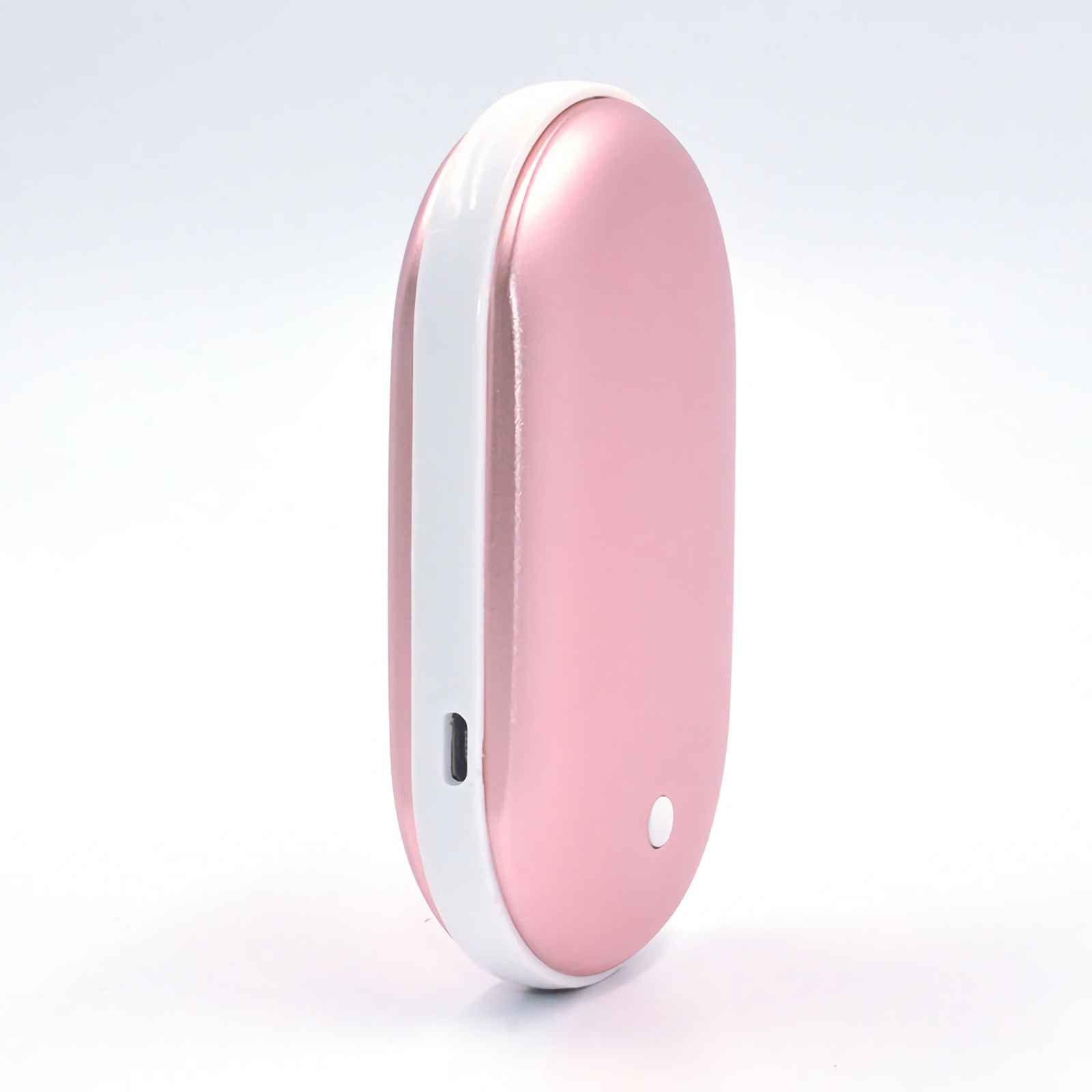 Ein rosa, ovalförmiger Handwärmer mit weißem Streifen an der Seite. Ein kleiner Knopf ist sichtbar.