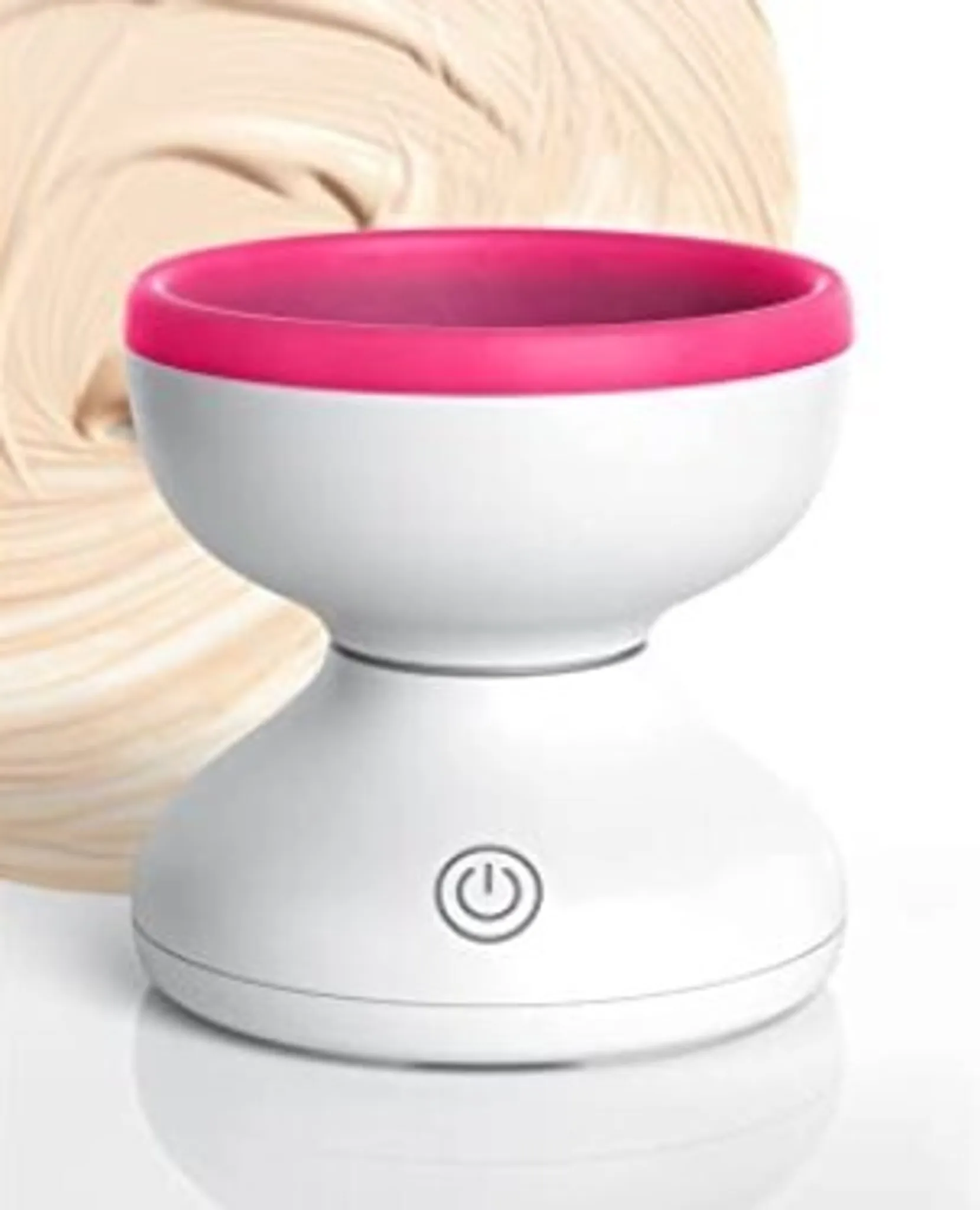 Weißes Gerät mit rosa Rand. Ein-/Aus-Taste an der Basis. Beigefarbener Wirbelhintergrund.