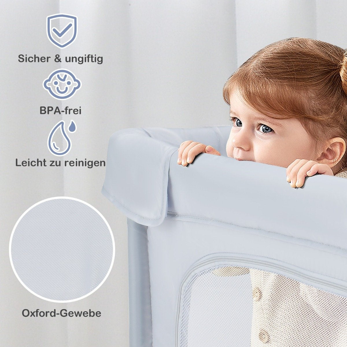 Una niña mira por encima de una cuna azul. Los iconos indican seguridad: no tóxico, sin BPA, fácil de limpiar y tejido Oxford.