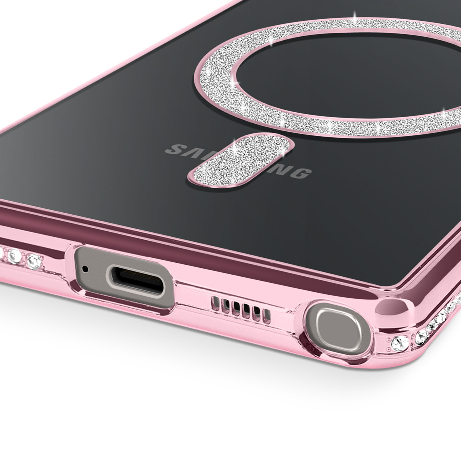 Custodia rosa per telefono con retro trasparente. Anello e accento argentati. Strass intorno al bordo. Logo Samsung visibile.