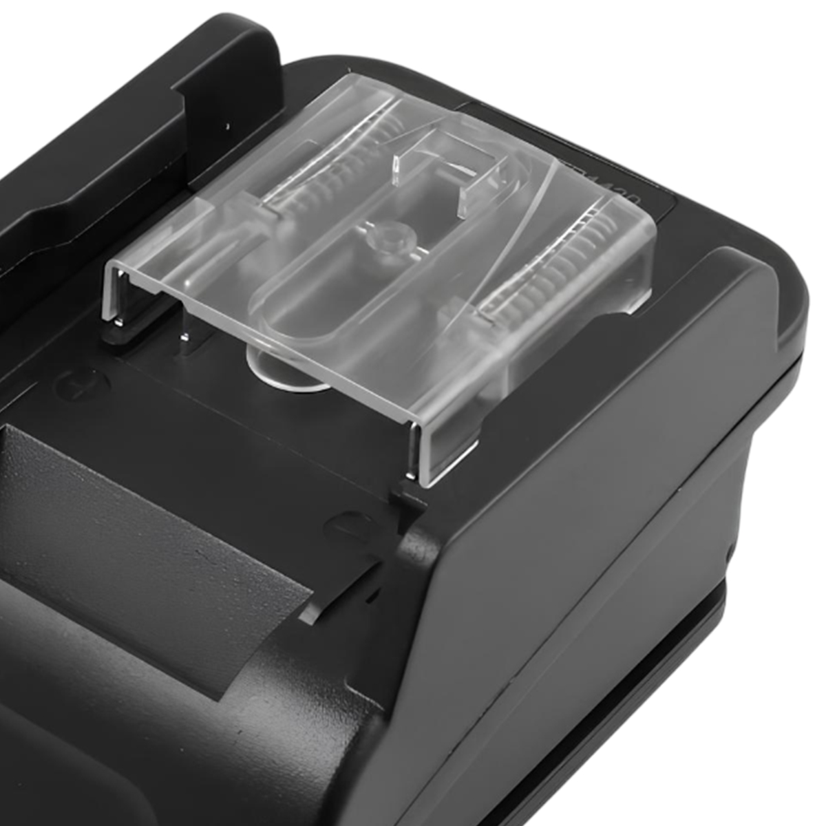 Gros plan d'un appareil noir avec un couvercle en plastique transparent et des ressorts métalliques. L'appareil est de forme rectangulaire et a une finition lisse.