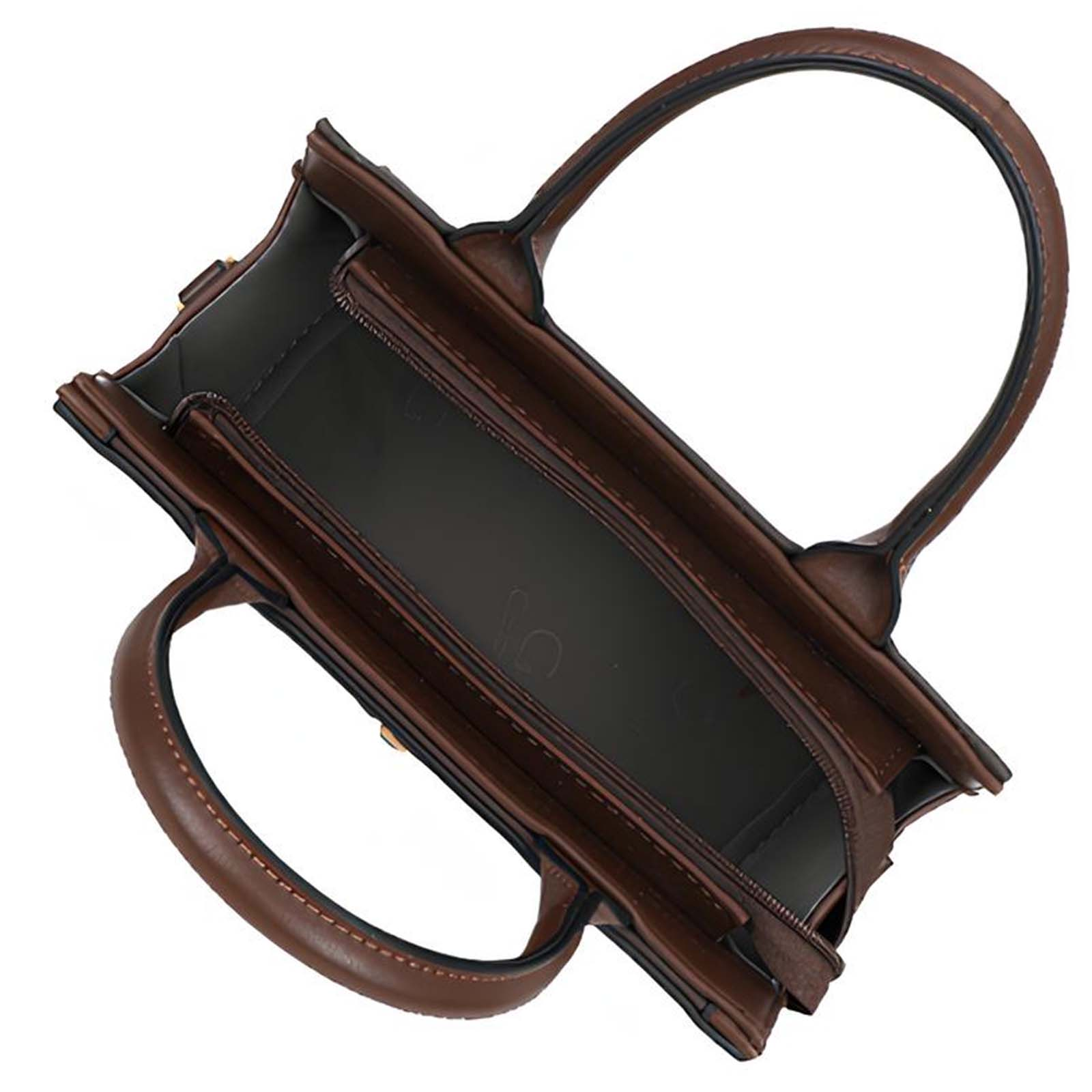 Un bolso de cuero marrón, abierto, con dos asas. El interior es oscuro y tiene una cremallera.