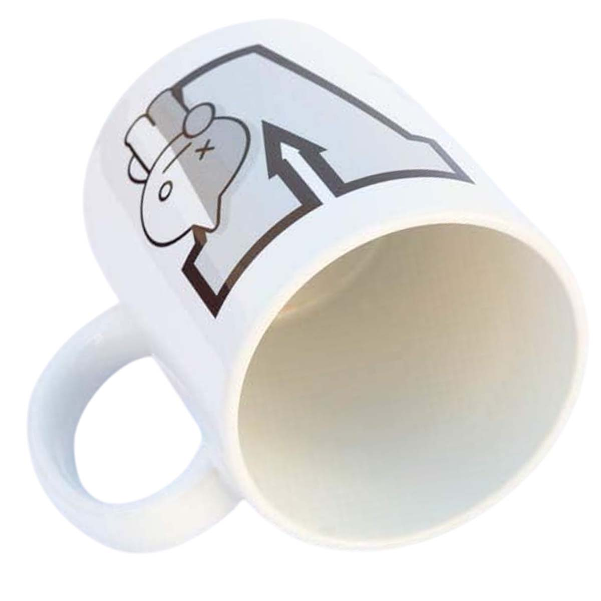Eine weiße Tasse mit einem Design eines Cartoon-Gesichts, einem Pfeil und dem Buchstaben A. Die Tasse ist leer und zum Betrachter geneigt.