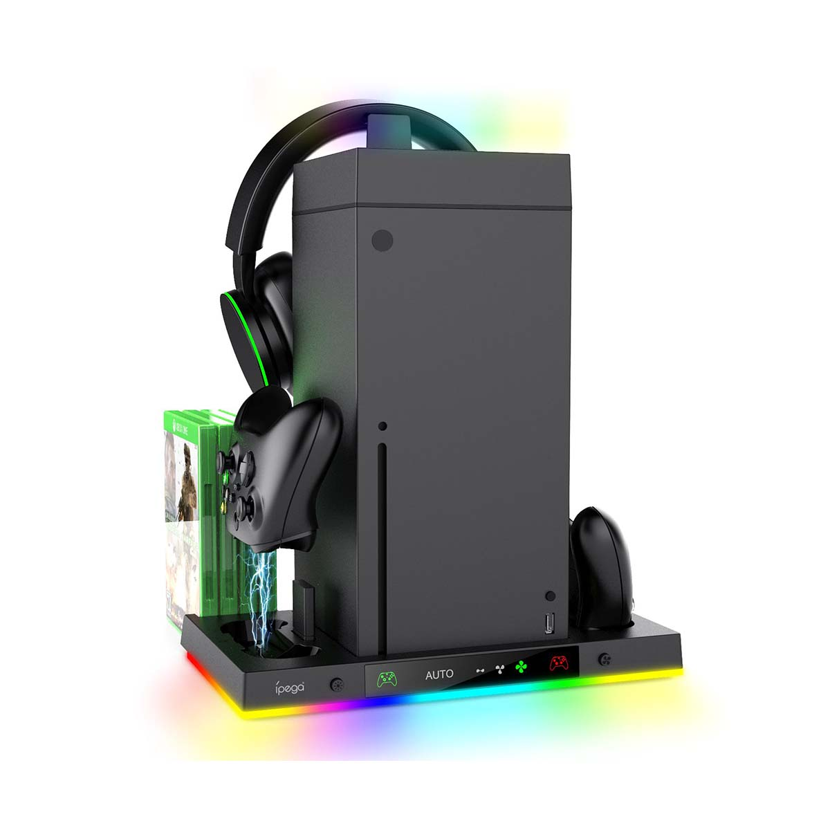 Consola de juegos negra con auriculares, mando y juegos. Está sobre un soporte con luces de colores.