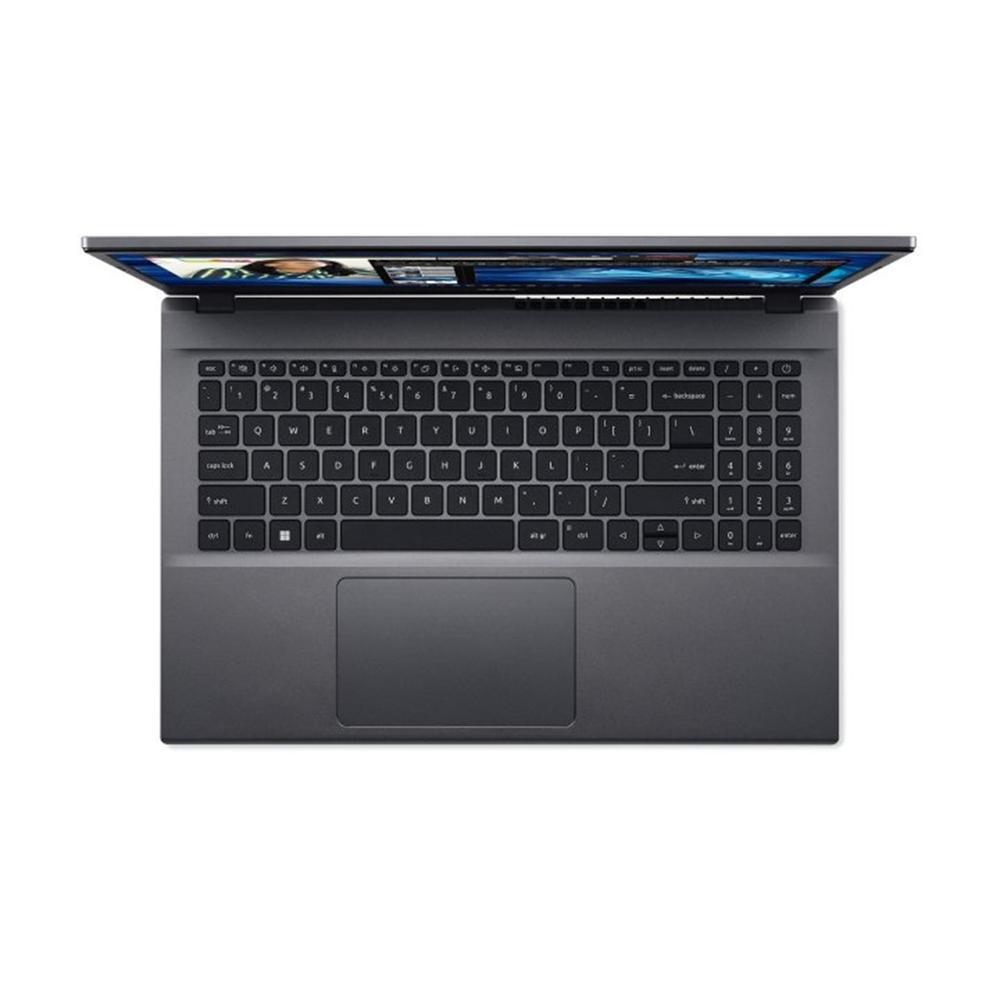 Un portátil gris con la pantalla abierta se muestra desde arriba. Teclado, panel táctil y pantalla son visibles, mostrando una imagen.