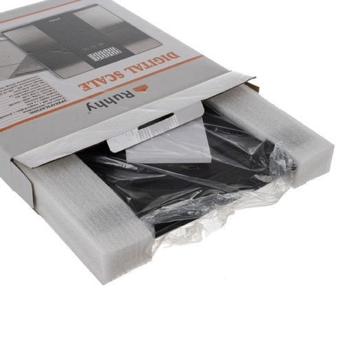 Una báscula digital en una caja. La caja está abierta, mostrando la báscula envuelta en plástico y espuma.