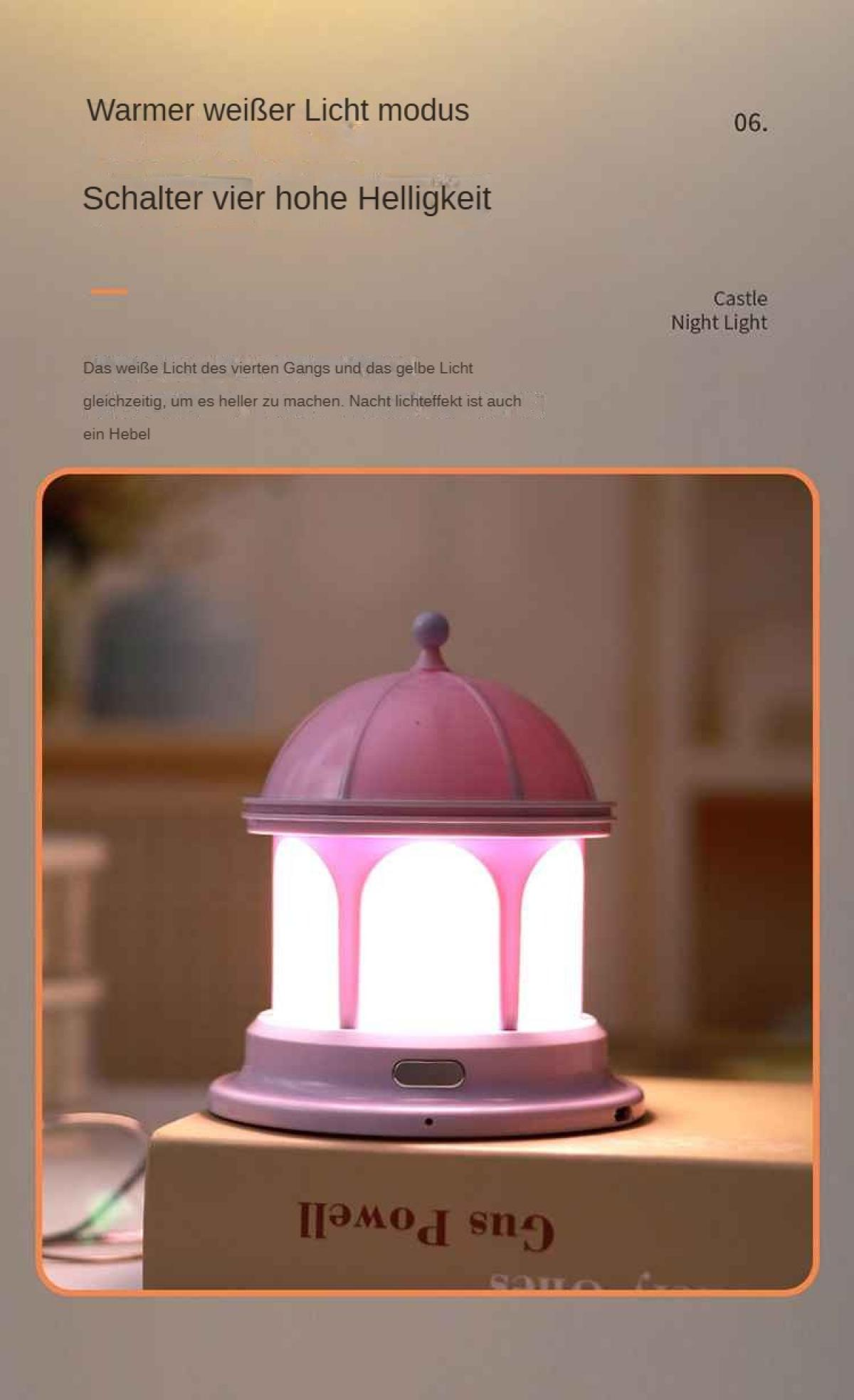 Ein rosa Burg-Nachtlicht steht auf einem Buch. Text auf Deutsch steht oben. Es hat eine Kuppel und ein hell leuchtendes Zentrum.