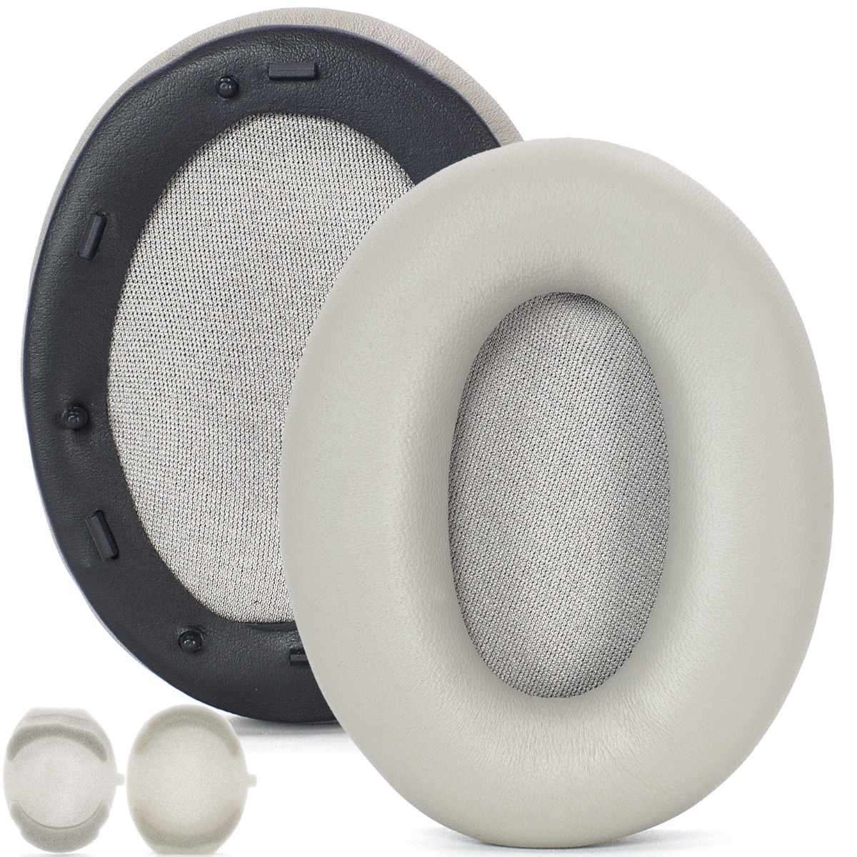 Dos almohadillas para auriculares, una gris claro, otra con borde negro. Pequeñas almohadillas blancas para auriculares en la parte inferior.