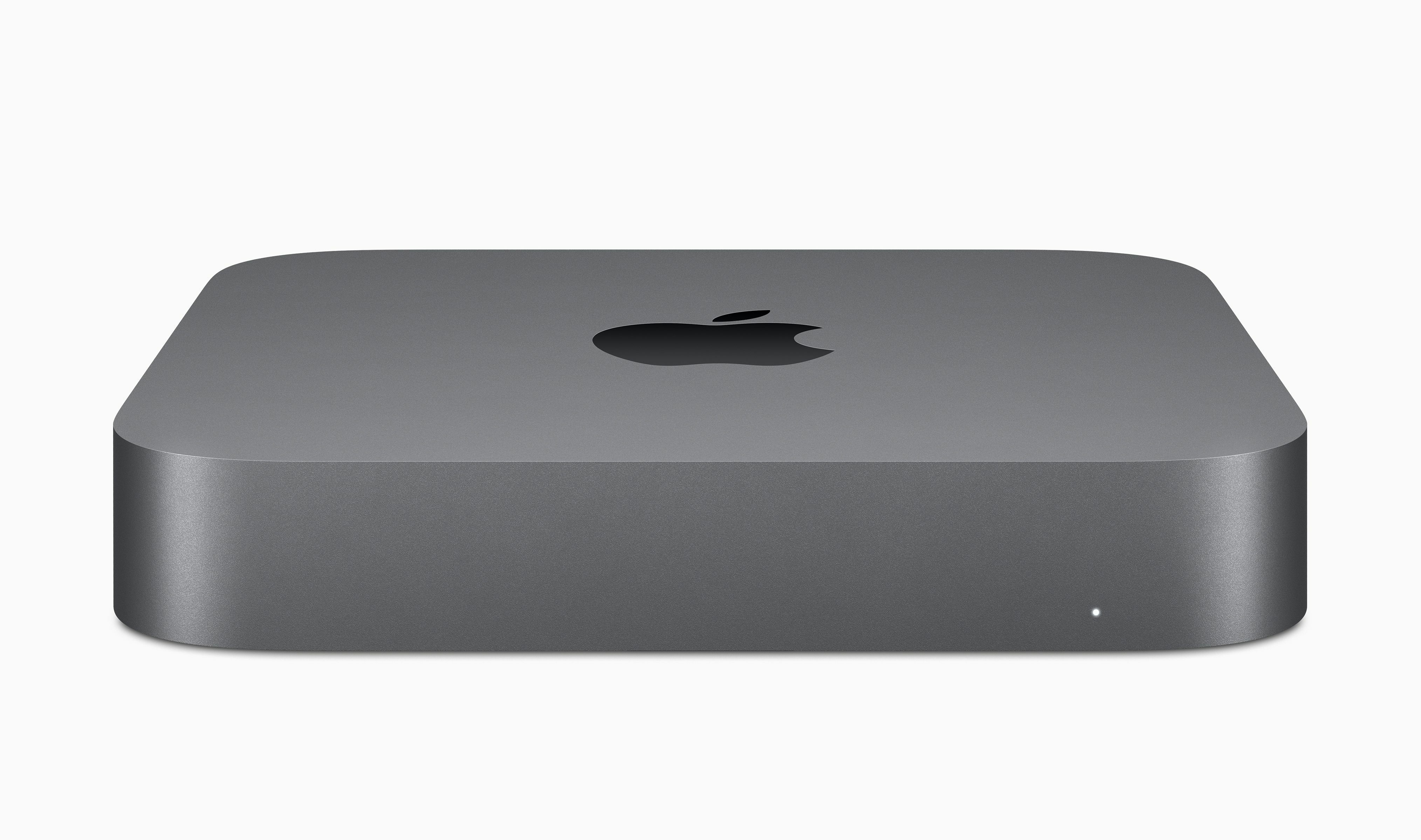 Szary komputer Apple Mac Mini. Ma logo Apple na górze i małe białe światło z przodu.