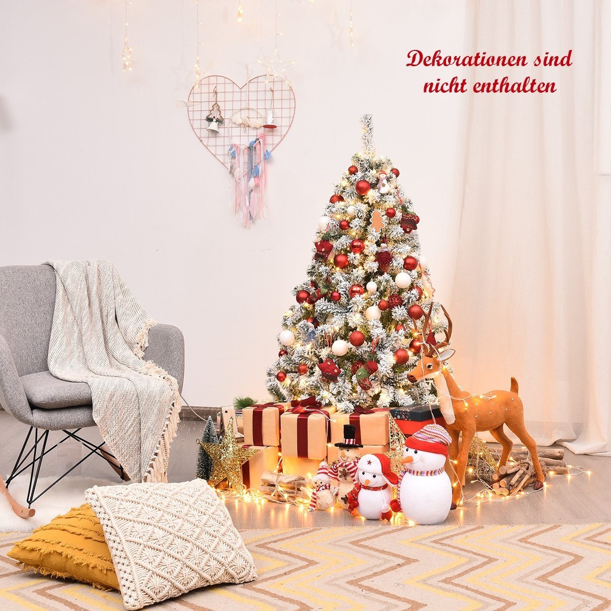 Un árbol de Navidad decorado con adornos y luces. Regalos, muñecos de nieve y un reno al frente. Una silla y almohadas a la izquierda.